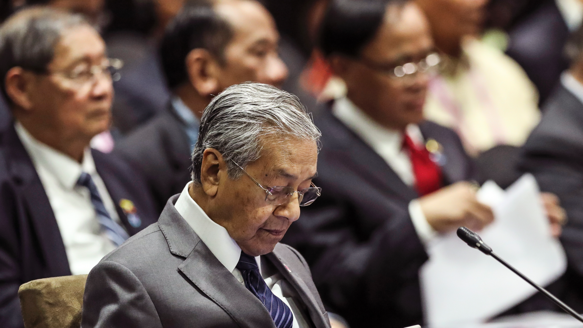 Malaysian Prime Minister Mahathir Mohamad uses his mobile phone during the 13th East Asian Summit Plenary on the sidelines of the 33rd ASEAN summit in Singapore, Thursday, Nov. 15, 2018. At 93, Malaysia’s comeback prime minister, Mahathir Mohamed, cuts a striking figure as the center of attention at a Southeast Asian summit in Singapore. (AP Photo/Yong Teck Lim)