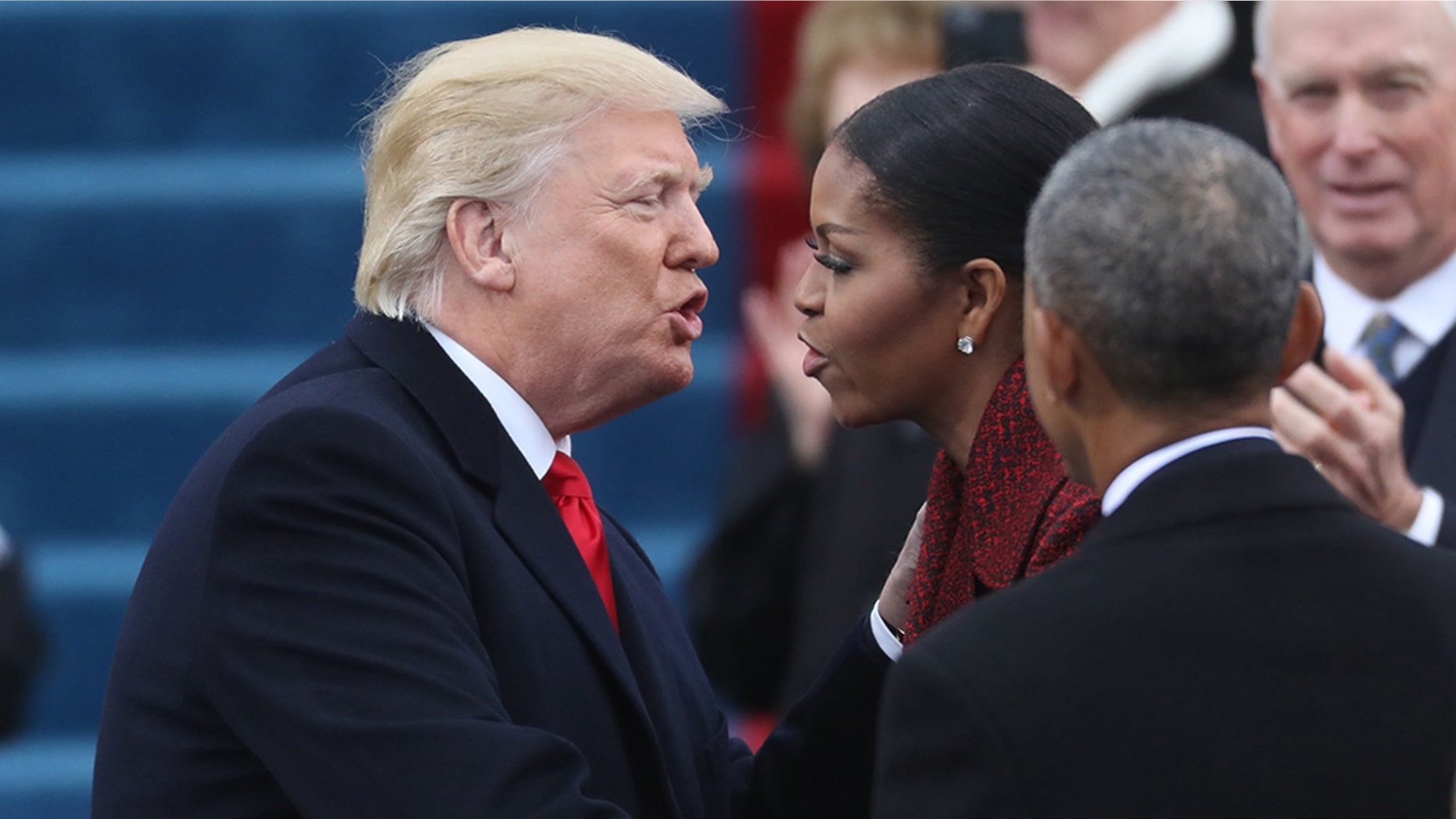 U.S. President-elect Donald Trump greets outgoing first lady Michelle Obama as President Barack Obama (R) looks on as they attends Trump's inauguration ceremonies on the Capitol in Washington, U.S., January 20, 2017. REUTERS/Carlos Barria - HT1ED1K1ABD04