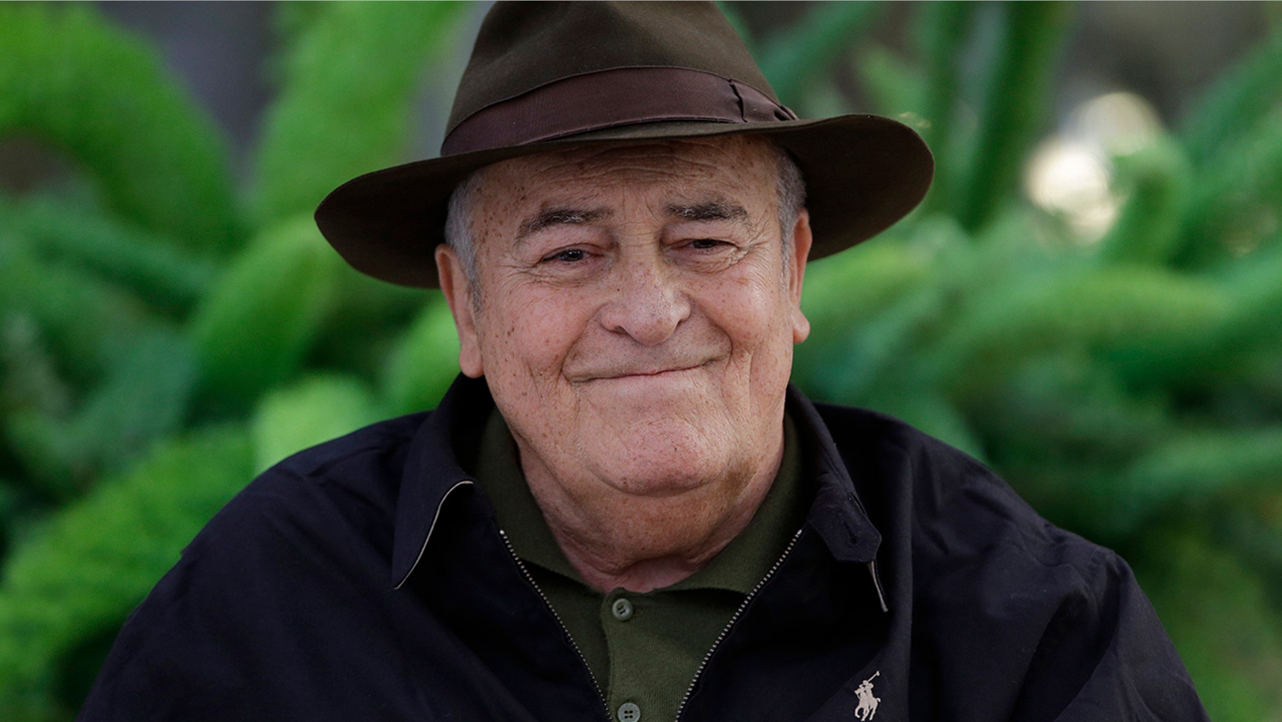 FILE - In this file photo taken on Oct. 18, 2012, Italian film director Bernardo Bertolucci poses for photographers during a photo call in Rome.