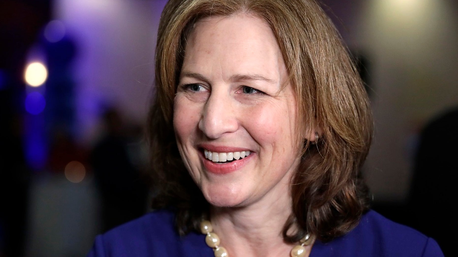 Congressional candidate Kim Schrier speaks with a reporter at an Election Night party for Democrats.