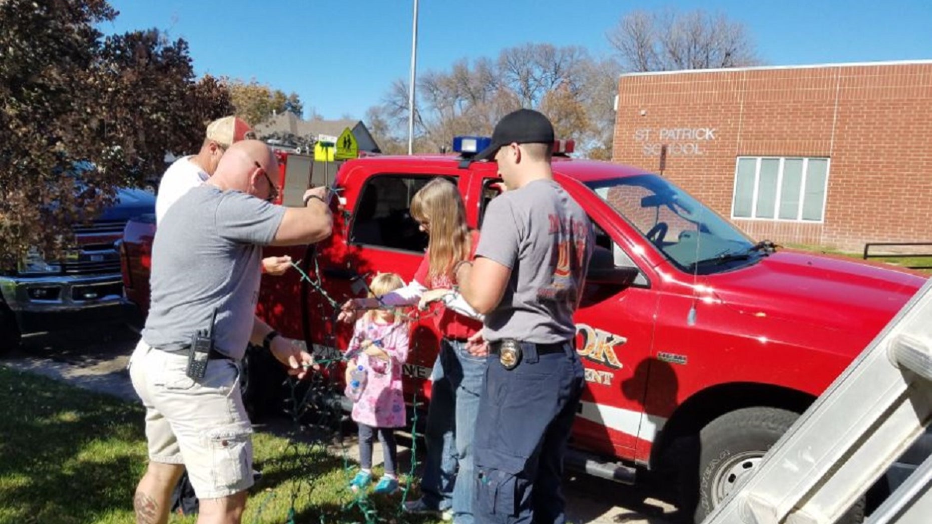 The McCook Fire Department gathered to help the family of Raleigh Haas put up Raleigh's Christmas lights.
