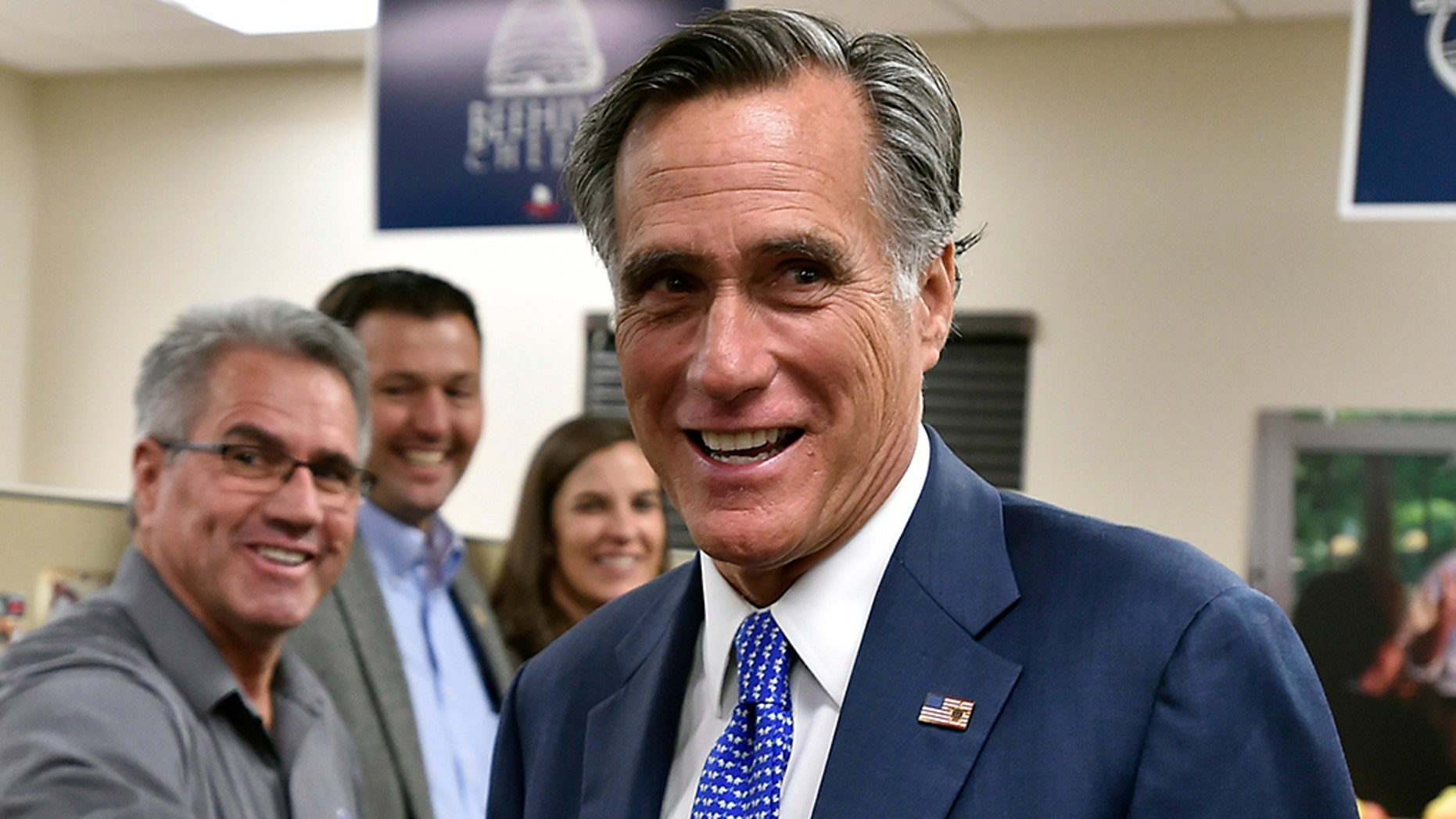Romney, answering critics, says country 