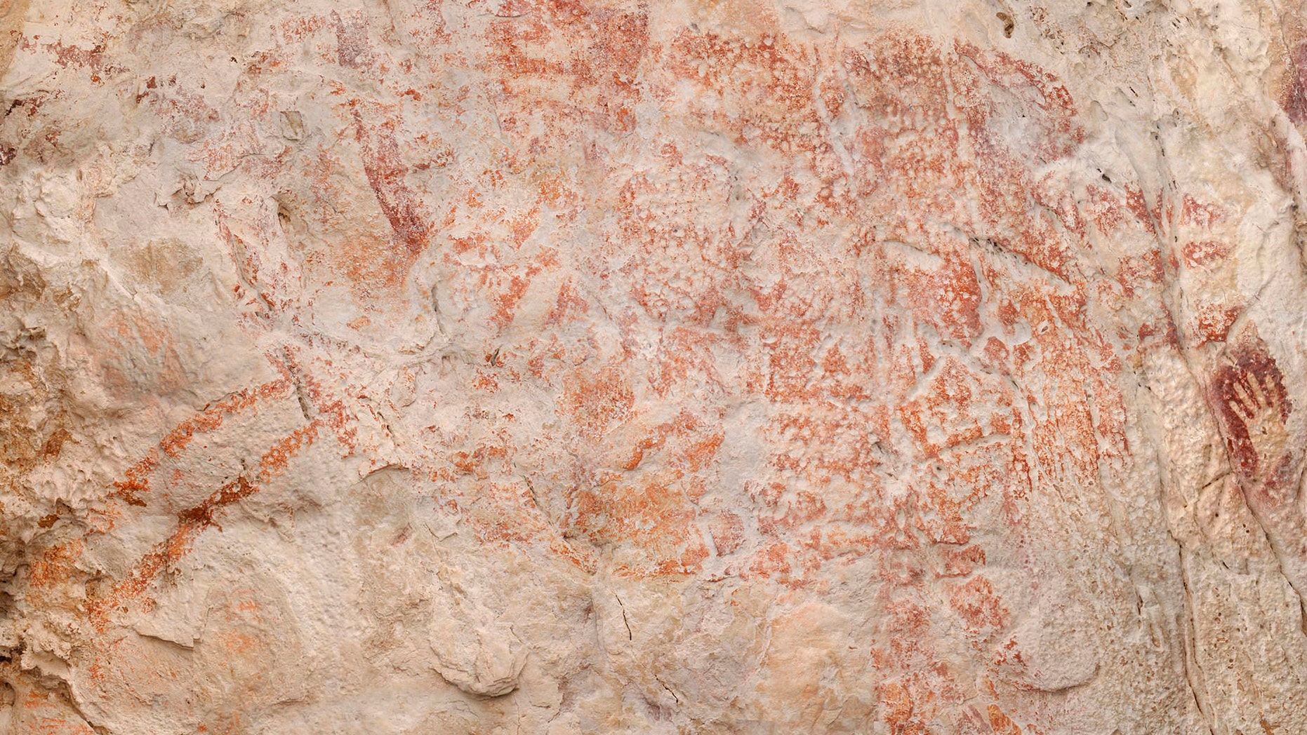 This composite image from the book "Borneo, Memory of the Caves" shows the world's oldest figurative artwork dated to a minimum of 40,000 years, in a limestone cave in the Indonesian part of the island of Borneo.