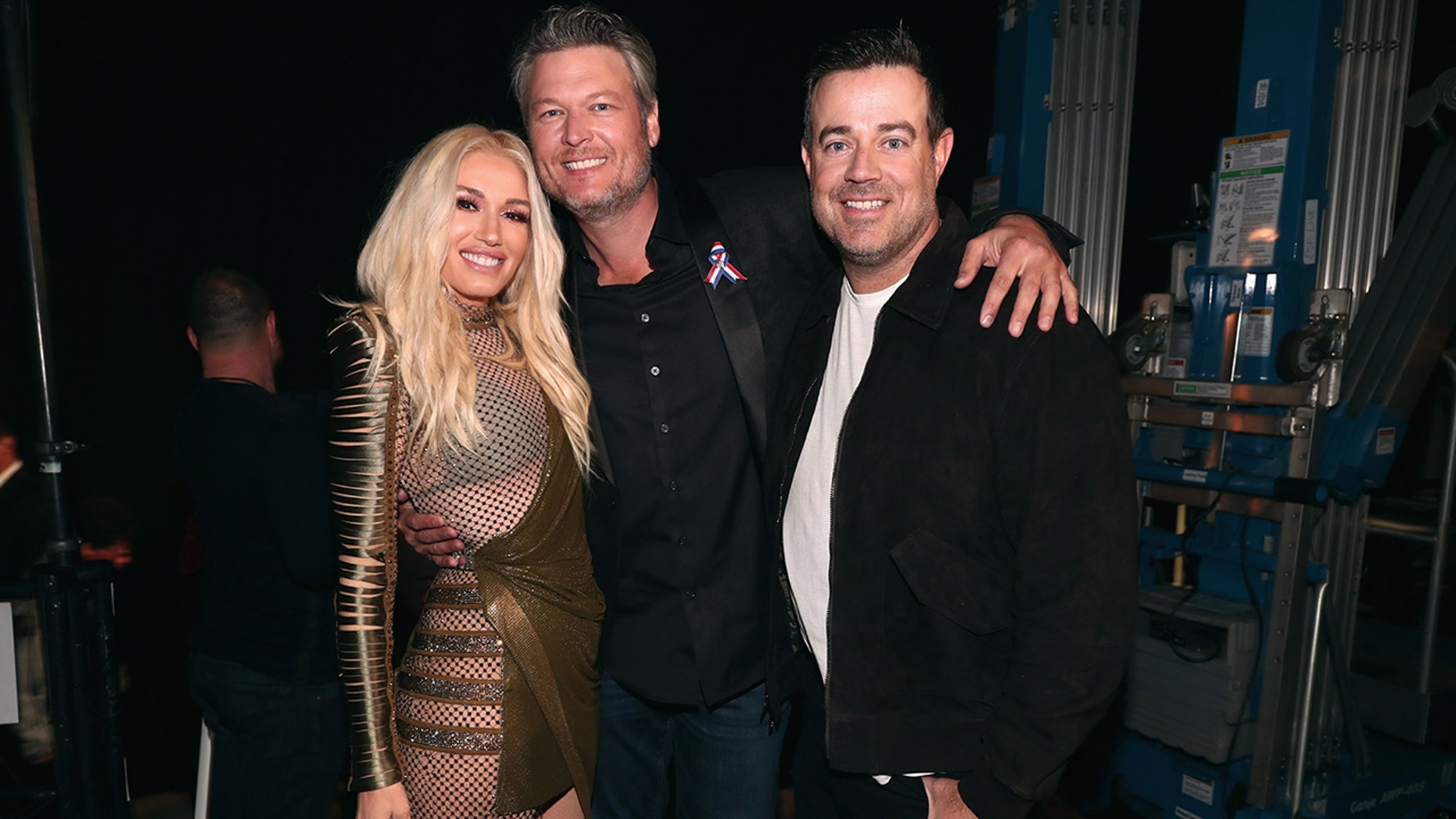 Pictured: Gwen Stefani and Blake Shelton, television personalities, and television personality Carson Daly at the 2018 E! The People's Choice Awards were held at Barker Hangar on November 11, 2018.