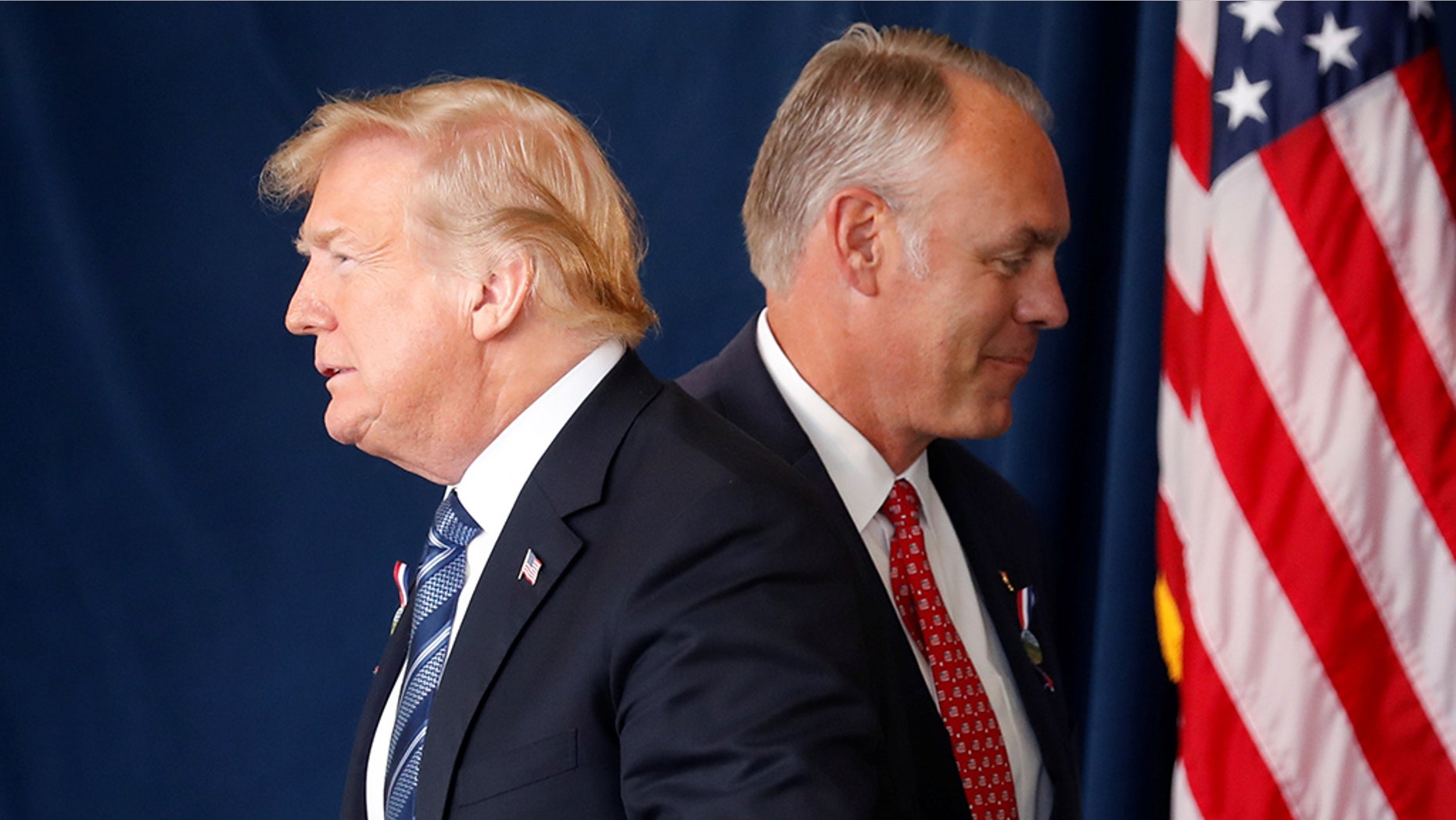 President Trump walks past Interior Secretary Ryan Zinke at a 9/11 observance in Pennsylvania.