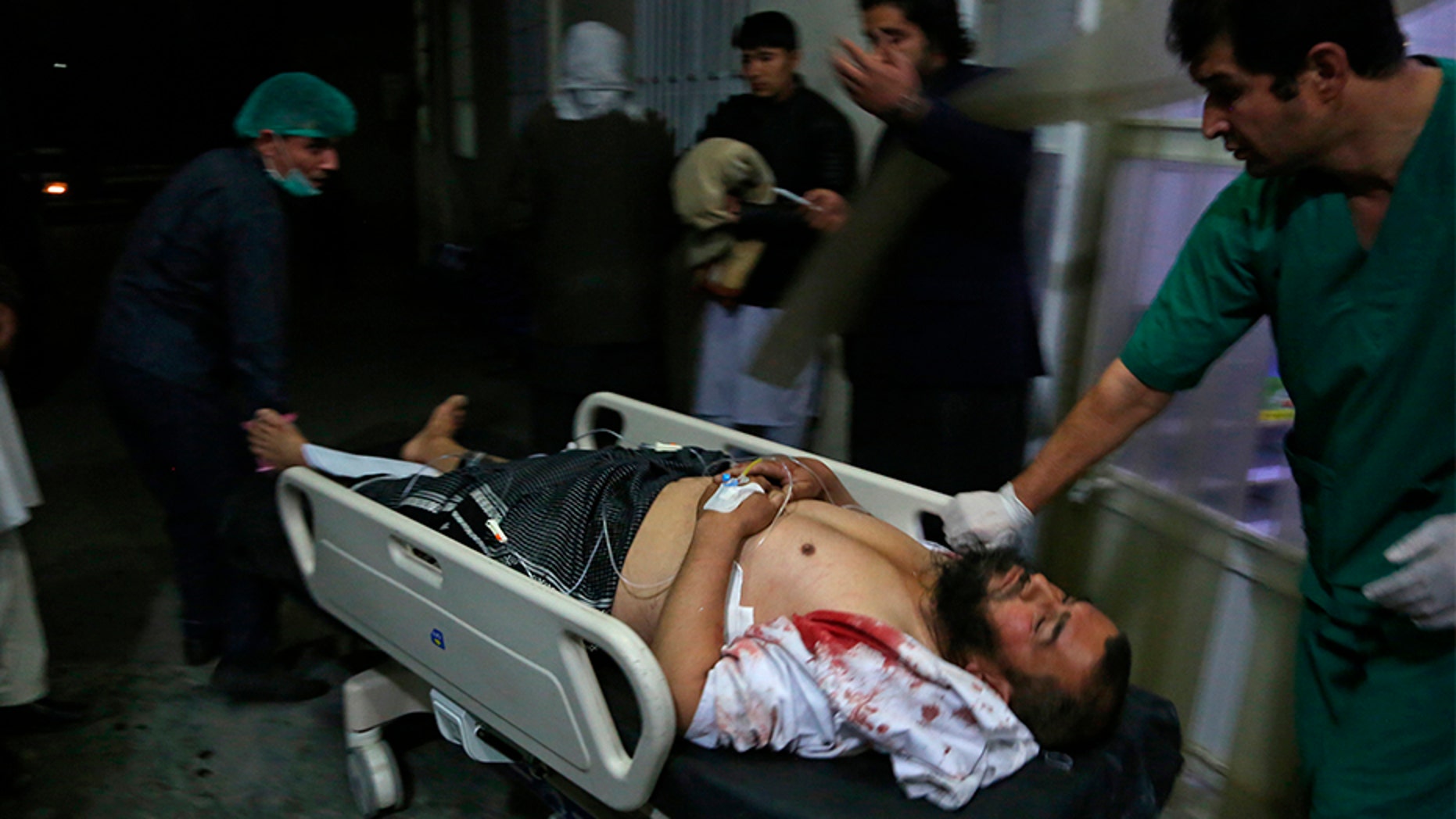 A man injured in a suicide bombing Monday is brought into a hospital in Kabul, Afghanistan.