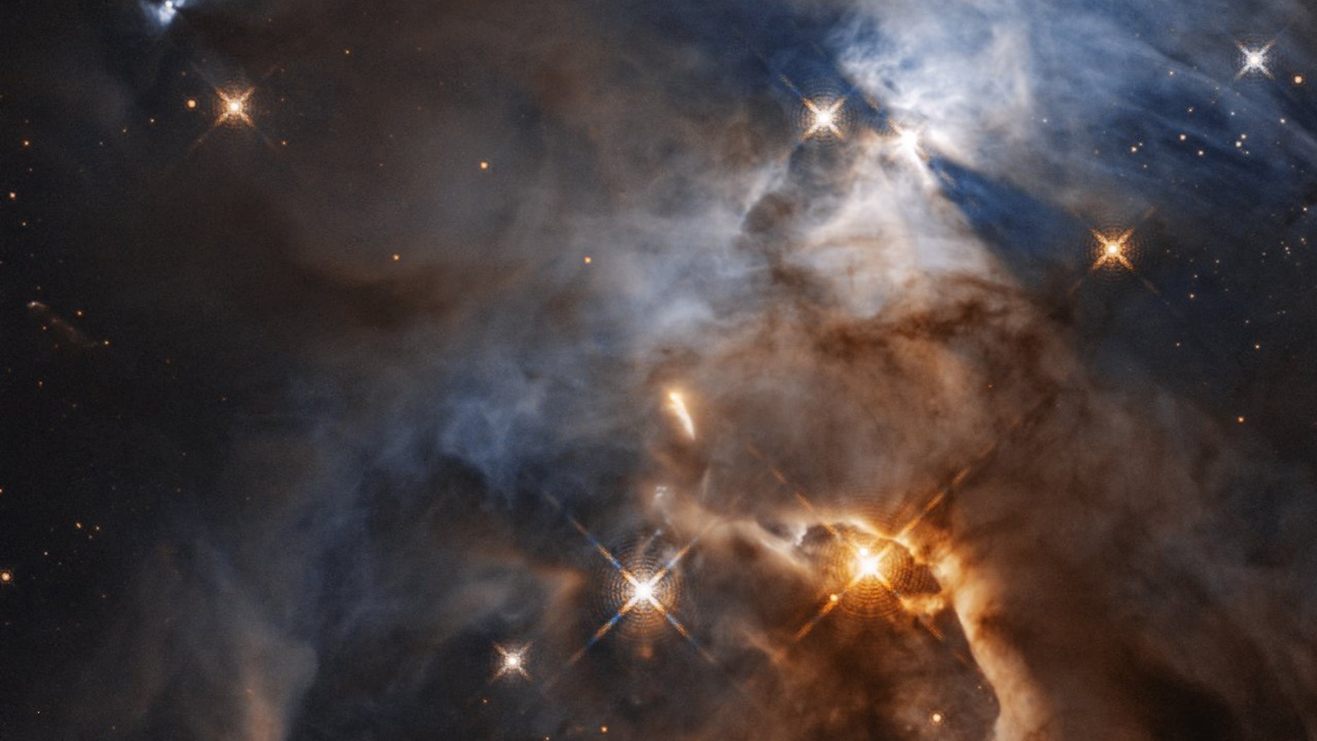 New research has found that alien life could be possible in solar systems where there are two young stars pushed together by a third passing by. (Serpens Nebula, a stellar nursery, is pictured) (Credit: NASA, ESA)