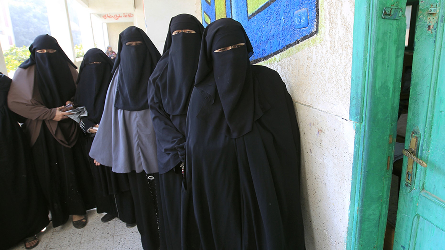 Niqab-clad Egyptian women line up to vote at a polling station in Qaliubia, north of Cairo, on January 4, 2012