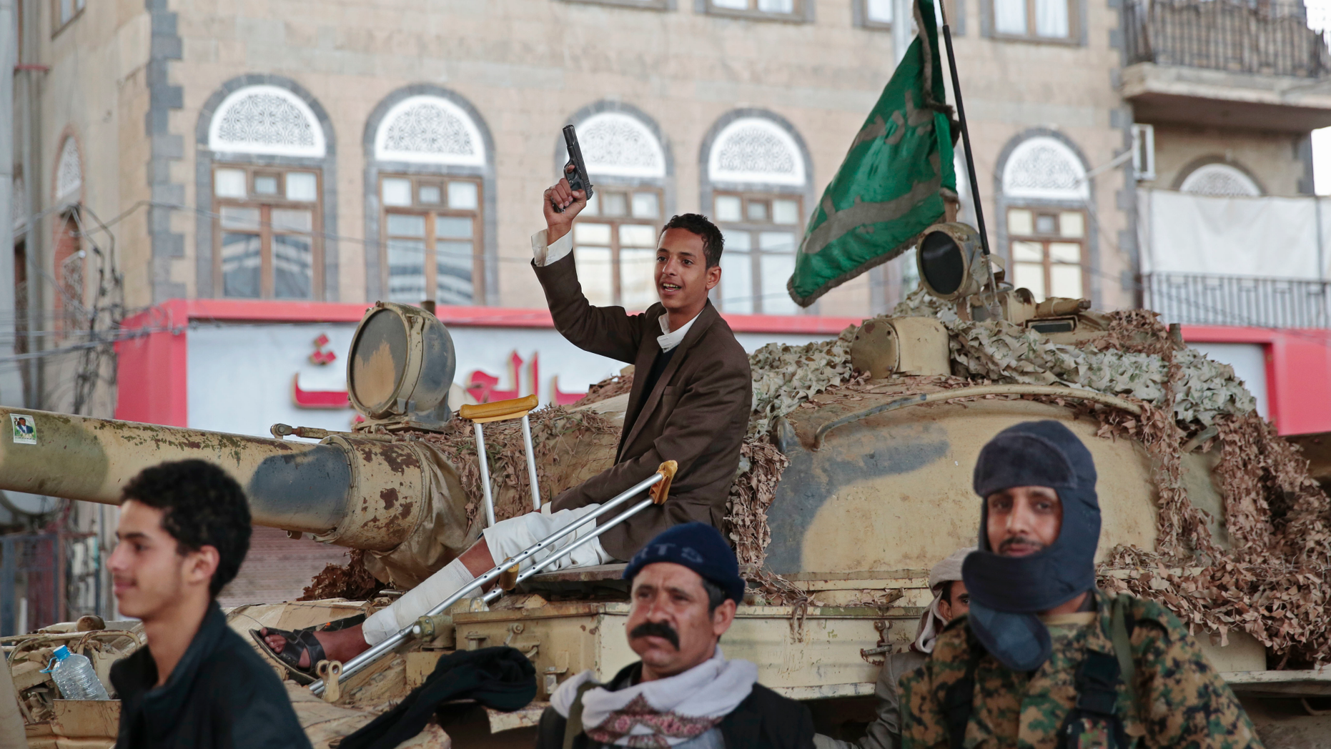 FILE - In this Dec. 4, 2017, file photo, Houthi Shiite fighters guard a street leading to the residence of former Yemeni President Ali Abdullah Saleh, in Sanaa, Yemen. A senior leader from Yemen’s Houthi rebels says that for the sake of peace efforts the group will halt rocket fire into Saudi Arabia, its larger northern neighbor who is leading a U.S.-backed Arab coalition to restore Yemen’s internationally recognized government. (AP Photo/Hani Mohammed, File)