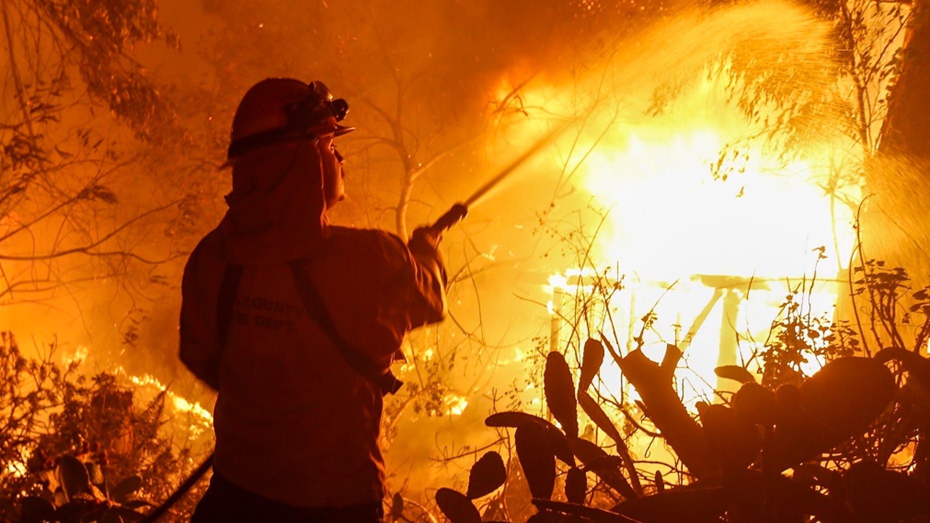A firefighter battles the Woolsey Fire in Malibu, Calif., last November.