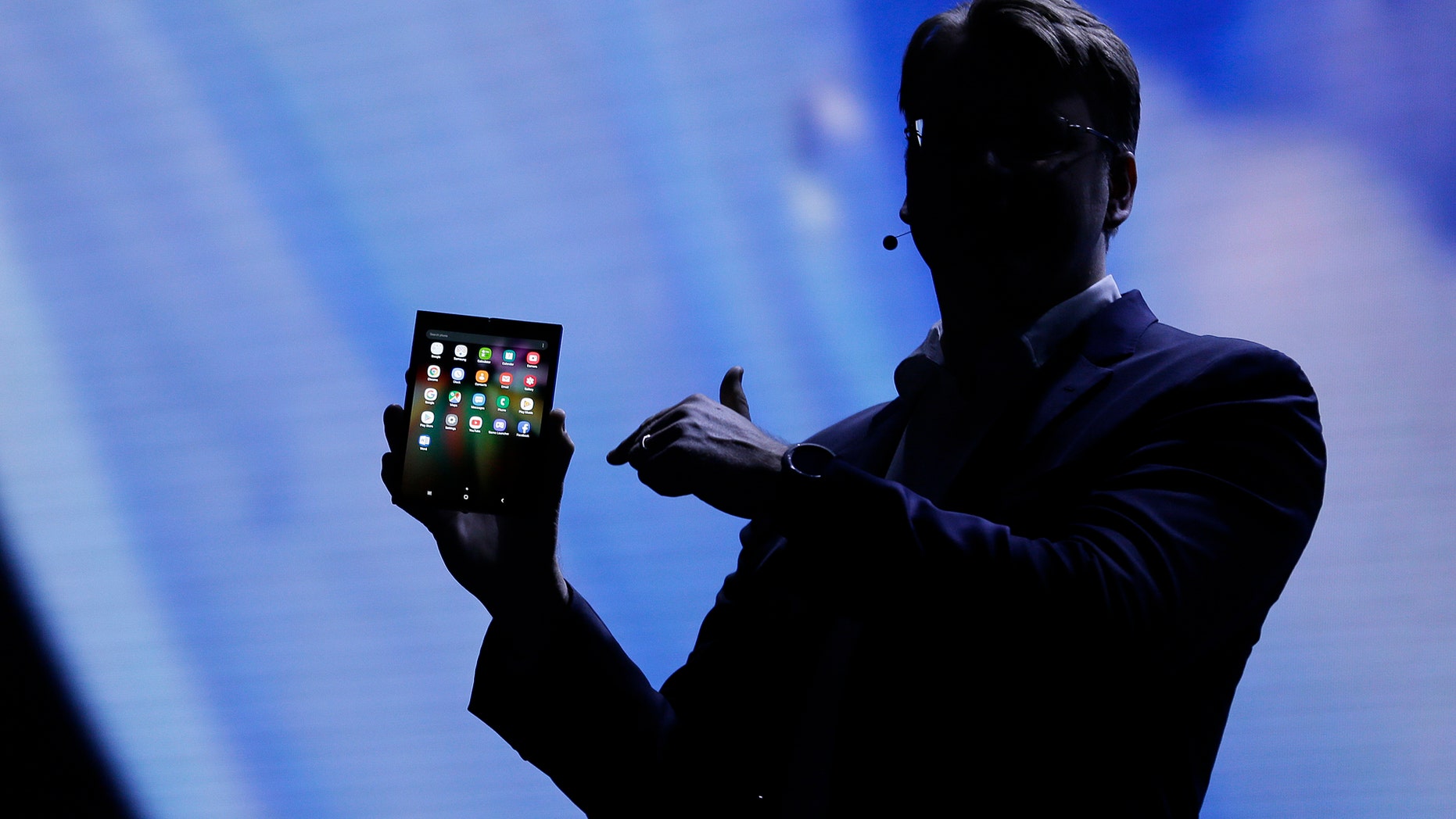 Justin Denison, SVP of Mobile Product Development, shows off the Infinity Flex Display of a folding smartphone during the keynote address of the Samsung Developer Conference Wednesday, Nov. 7, 2018, in San Francisco. (AP Photo/Eric Risberg)