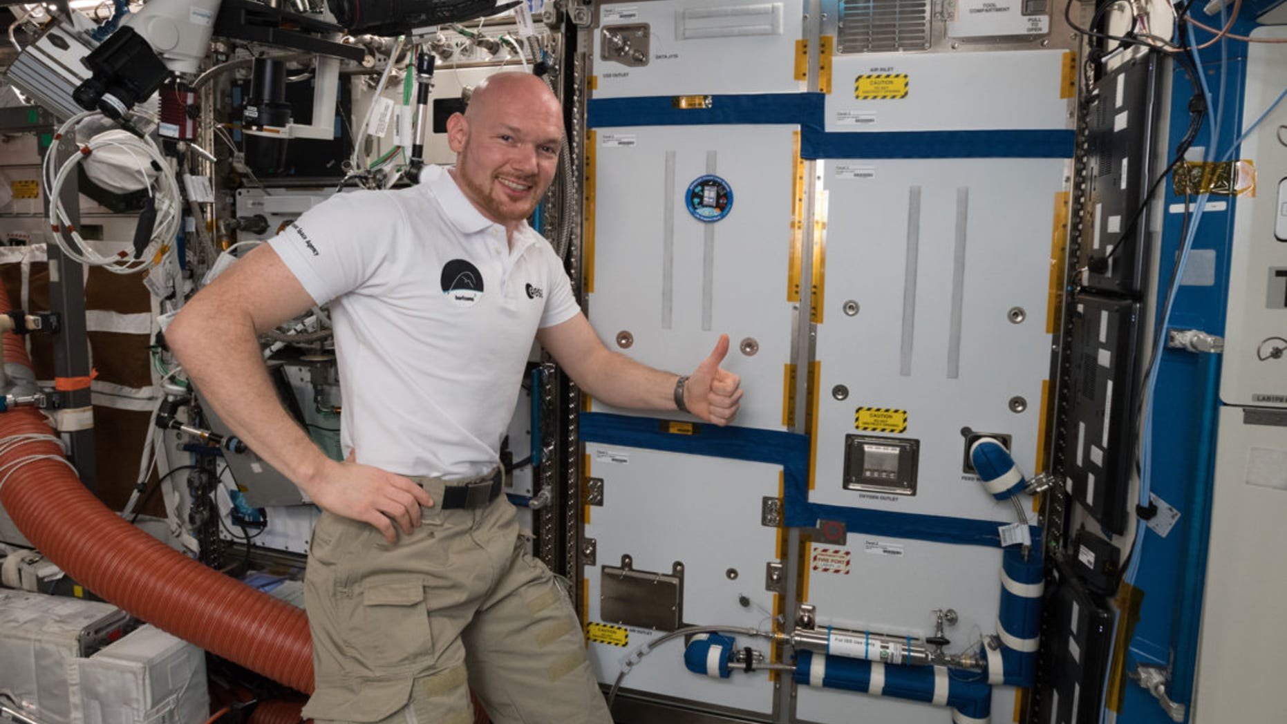 ESA astronaut Alexander Gerst poses on Oct. 19, 2018, with the ACLS life-support rack, newly installed on the International Space Station.