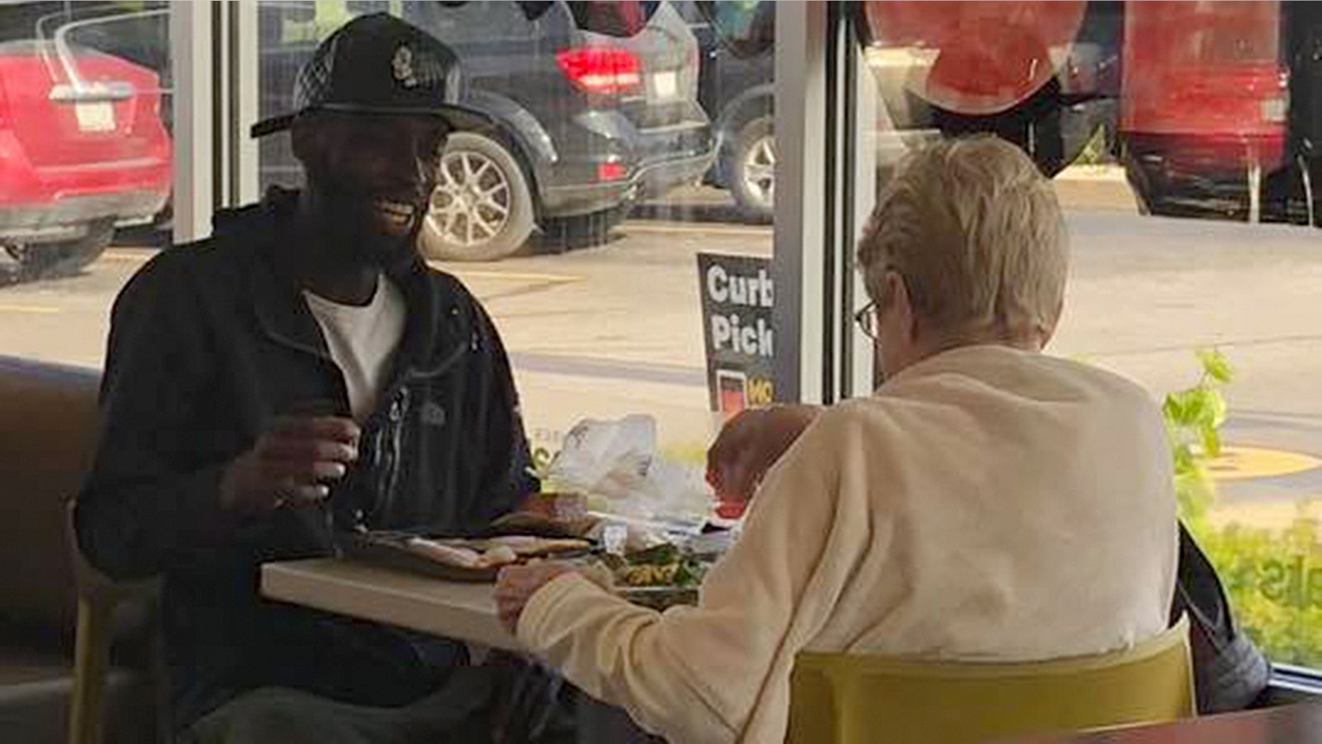 A pair of strangers sharing a meal at McDonald's has caught the attention of social media.