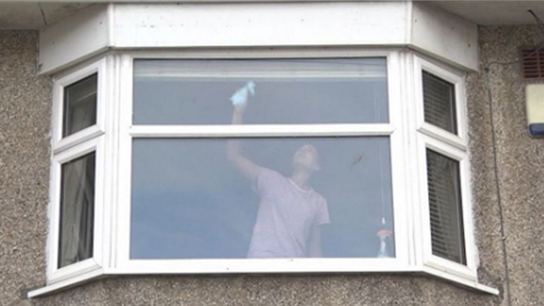 This seemingly innocuous photograph of a woman cleaning her windows has been shared with a shocking warning