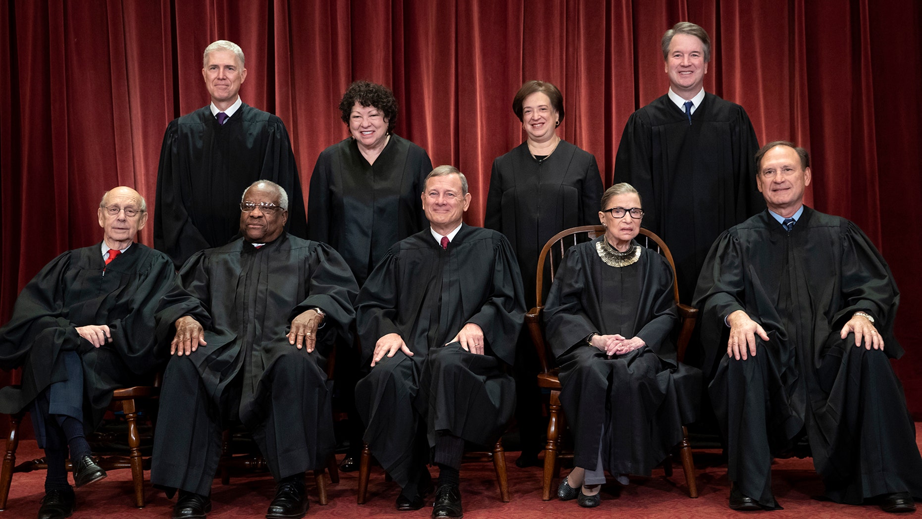 The justices of the U.S. Supreme Court gather for a formal group portrait to include the new Associate Justice, top row, far right, at the Supreme Court Building in Washington, Friday, Nov. 30, 2018. (AP Photo/J. Scott Applewhite)