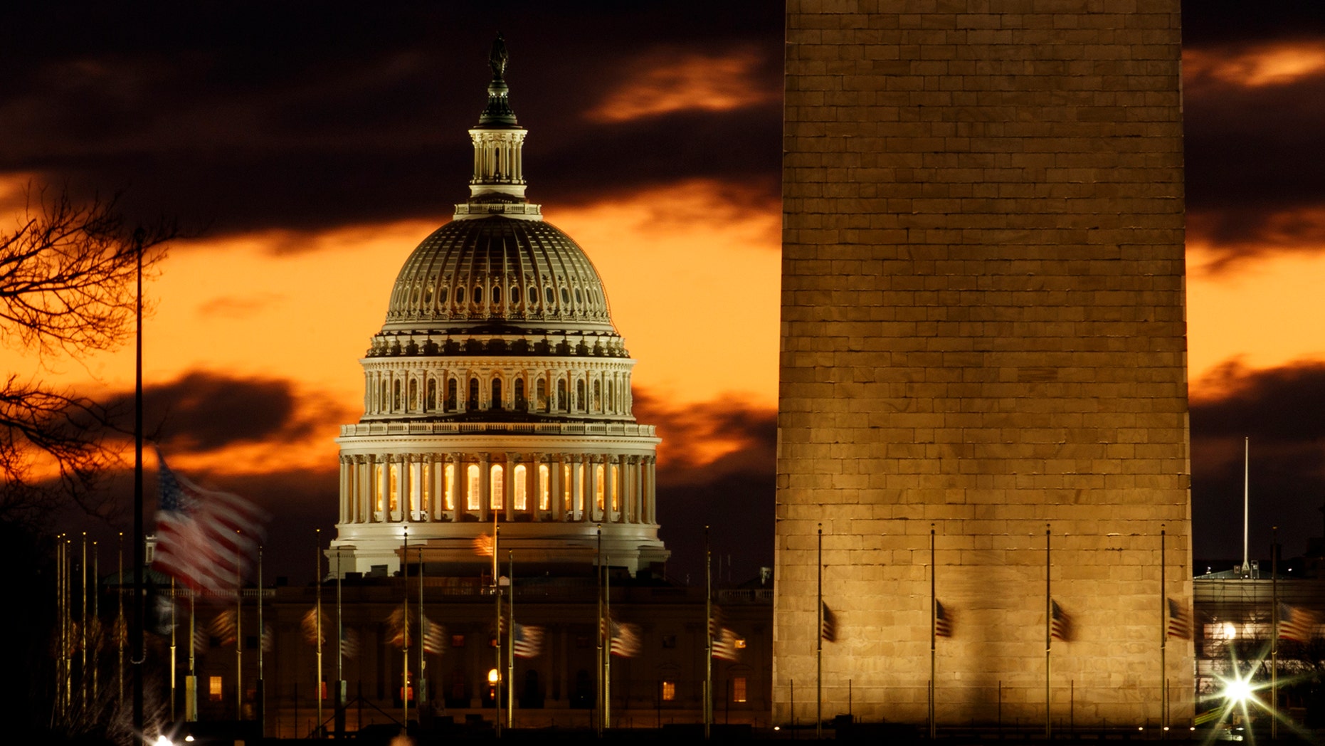 The U.S. Capitol dome is seen past the base of the Washington Monument just before sunrise in Washington, Saturday, Dec. 22, 2018. (AP Photo/Carolyn Kaster)