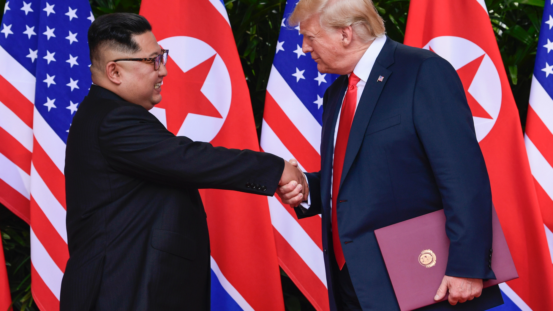 FILE - In this June 12, 2018, file photo, North Korea leader Kim Jong Un, left, and U.S. President Donald Trump shake hands at the conclusion of their meetings at the Capella resort on Sentosa Island in Singapore. To hear a beaming Donald Trump at his June summit with Kim Jong Un in Singapore, the solution to North Korea’s headlong pursuit of nuclear weapons, a foreign policy nightmare that has flummoxed U.S. leaders since the early 1990s, was at hand. (AP Photo/Susan Walsh, Pool, Fie)