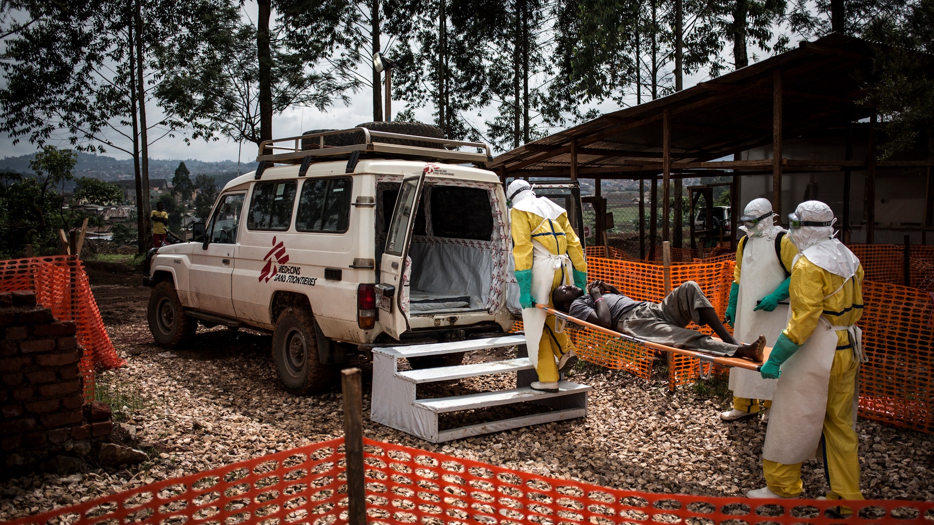 In this photo taken Nov. 4, 2018 and made available Dec. 4, 2018, health workers move a patient to a hospital after he was cleared of having Ebola inside of a Medecins Sans Frontieres (MSF) supported Ebola treatment centre in Butembo, Congo.
