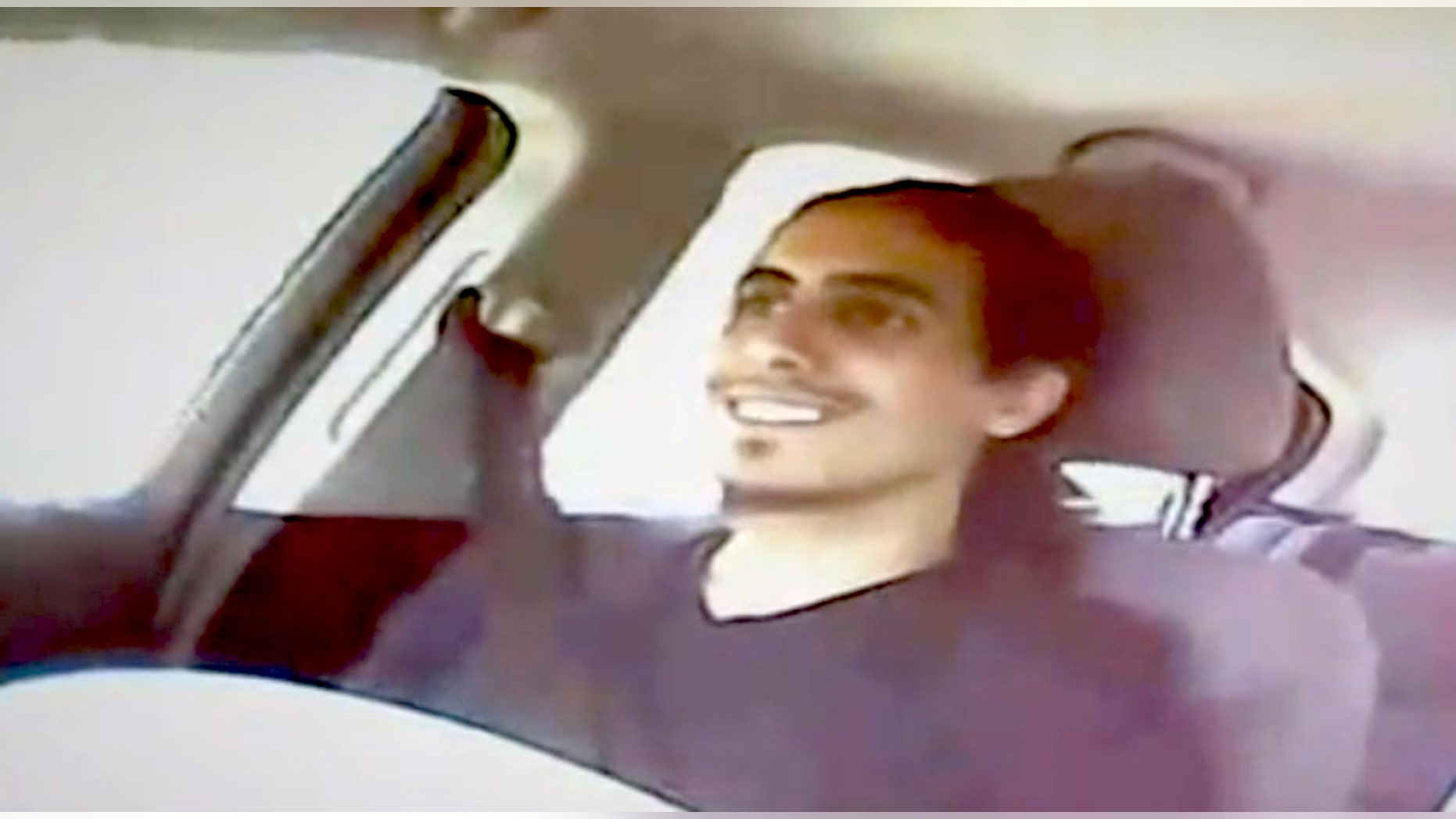 This image from video shows Amer Alhaggagi riding with an undercover FBI agent.