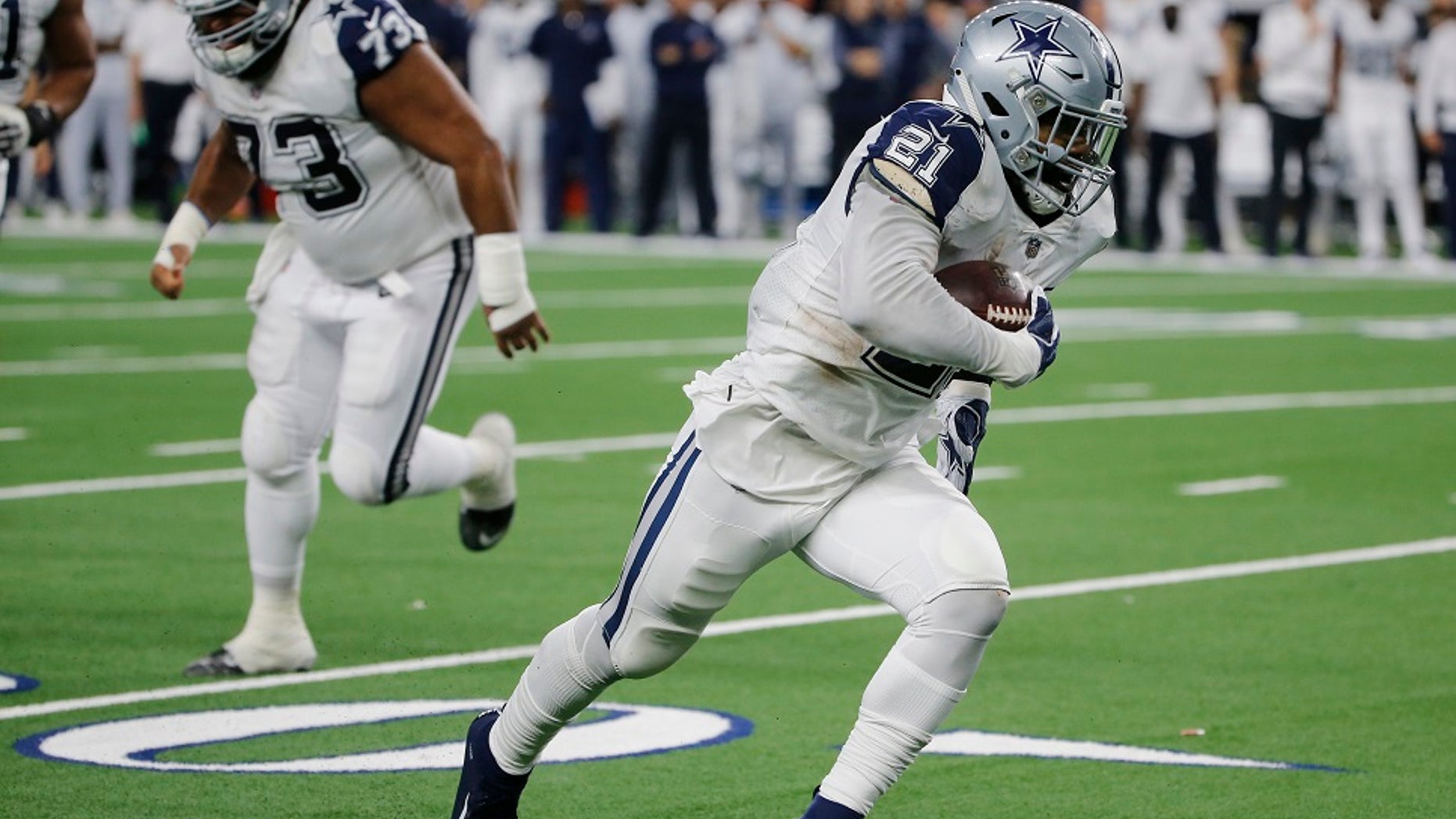 Dallas Cowboys running back Ezekiel Elliott (21) scores a touchdown against the New Orleans Saints in the first half of an NFL football game, in Arlington, Texas, on Thursday, Nov. 29.