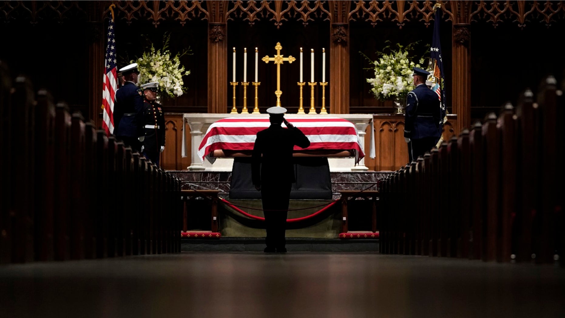 People pay their respects as the flag-draped casket of former President George H.W. Bush lies in repose at St. Martin's Episcopal Church Wednesday, Dec. 5, 2018, in Houston.