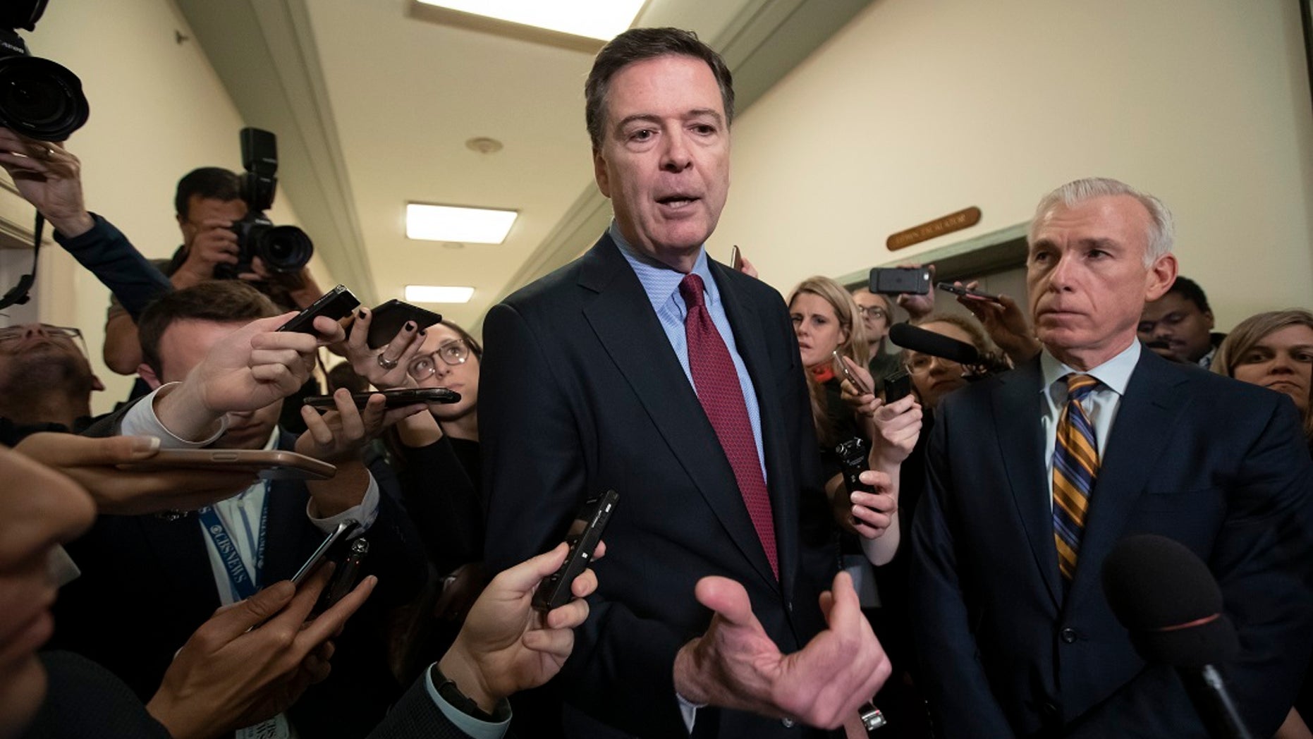 Former FBI Director James Comey, with his attorney, David Kelley, right, speaks to reporters after a day of testimony before the House Judiciary and Oversight committees, on Capitol Hill in Washington, Dec. 7, 2018. (Associated Press)