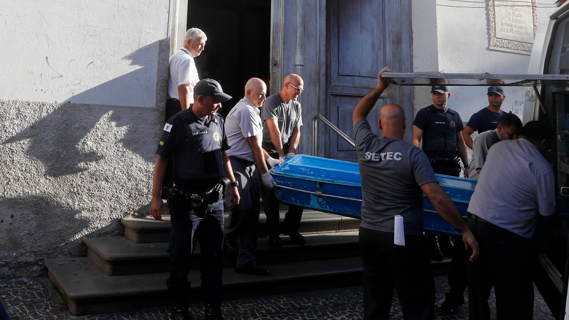 Police remove the body of a shooting victim from the Metropolitan Cathedral in Campinas, Brazil, Tuesday, Dec. 11, 2018. A man opened fire in the cathedral after Mass on Tuesday, killing four and leaving four others injured before taking a bullet in the ribs in a firefight with police and then shooting himself in the head, according to authorities. (AP Photo/Victor R. Caivano)