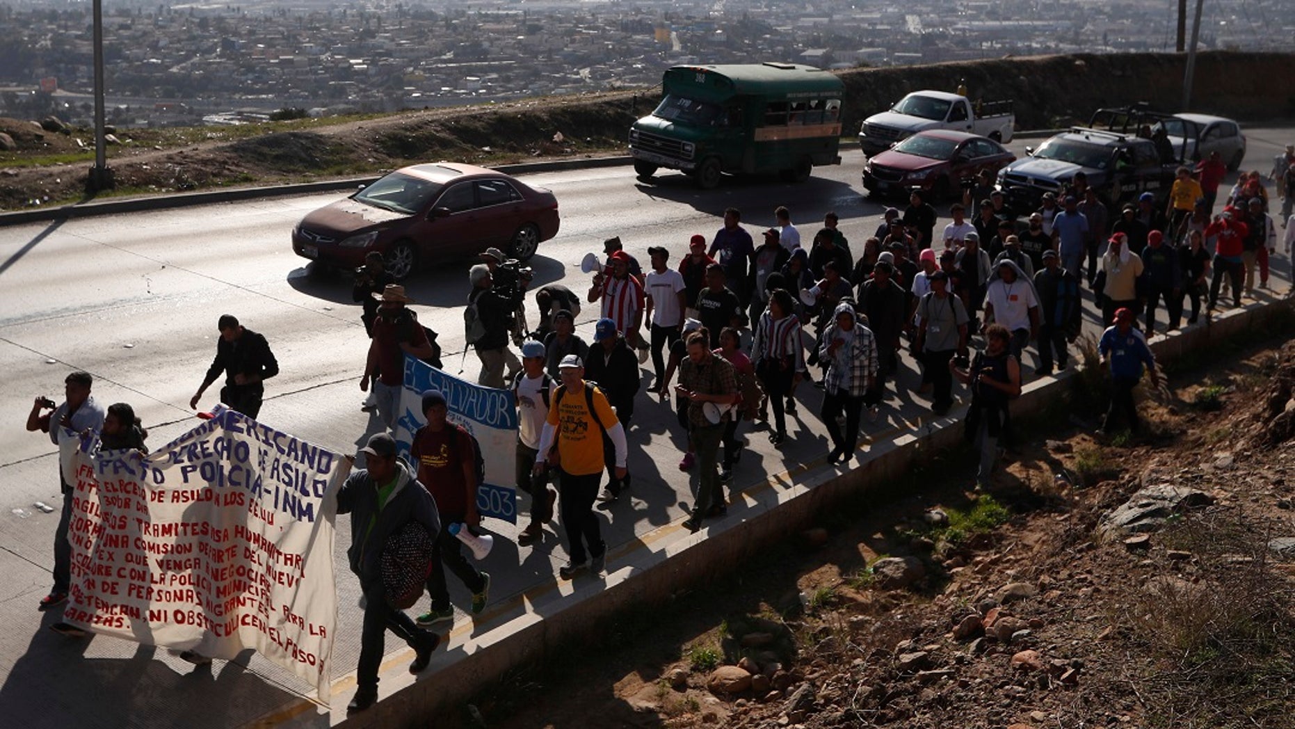 Central American migrants march to the U.S. consulate in Tijuana, Mexico, Tuesday, Dec. 11, 2018. (AP Photo/Moises Castillo)