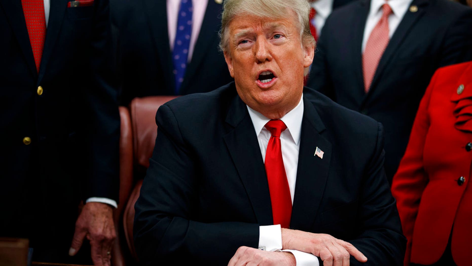 FILE: President Donald Trump signs a criminal reform reform in the White House Oval Office in Washington.
