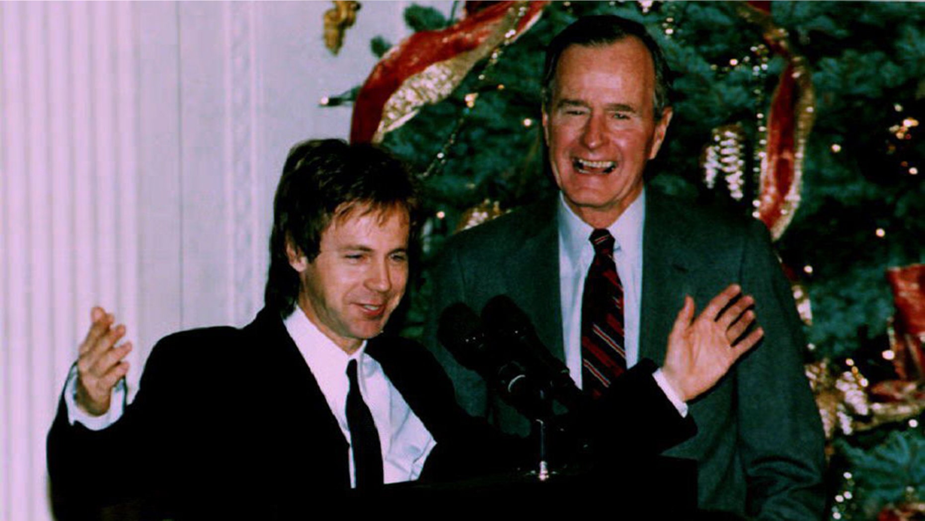 President George H.W. Bush watches as comedian Dana Carvey does his George Bush impersonation in 1992.