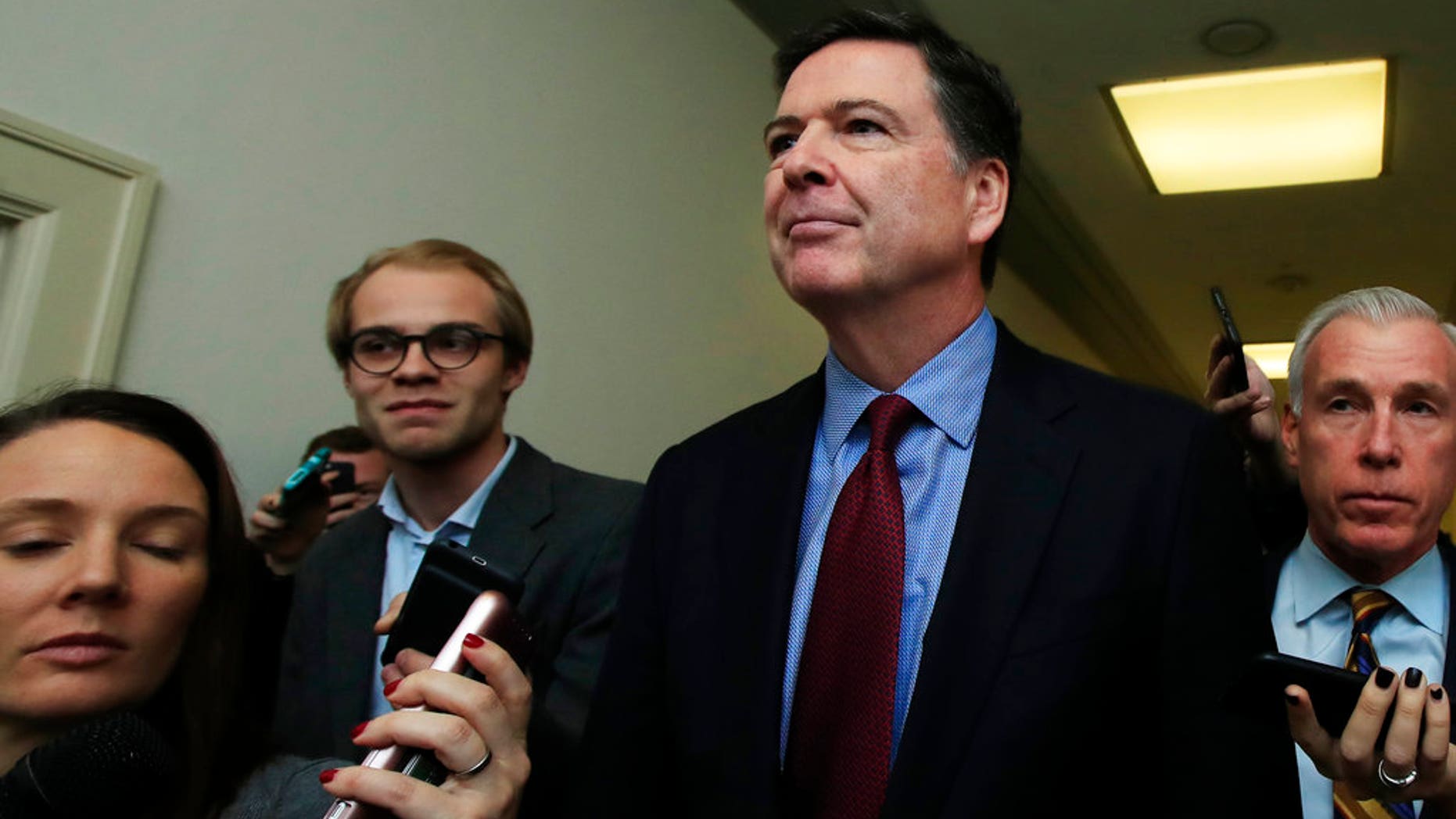 Former FBI Director James Comey speaks to reporters after testifying under subpoena behind closed doors before the House Judiciary and Oversight Committee on Capitol Hill in Washington, Friday, Dec. 7, 2018. (AP Photo/Manuel Balce Ceneta)