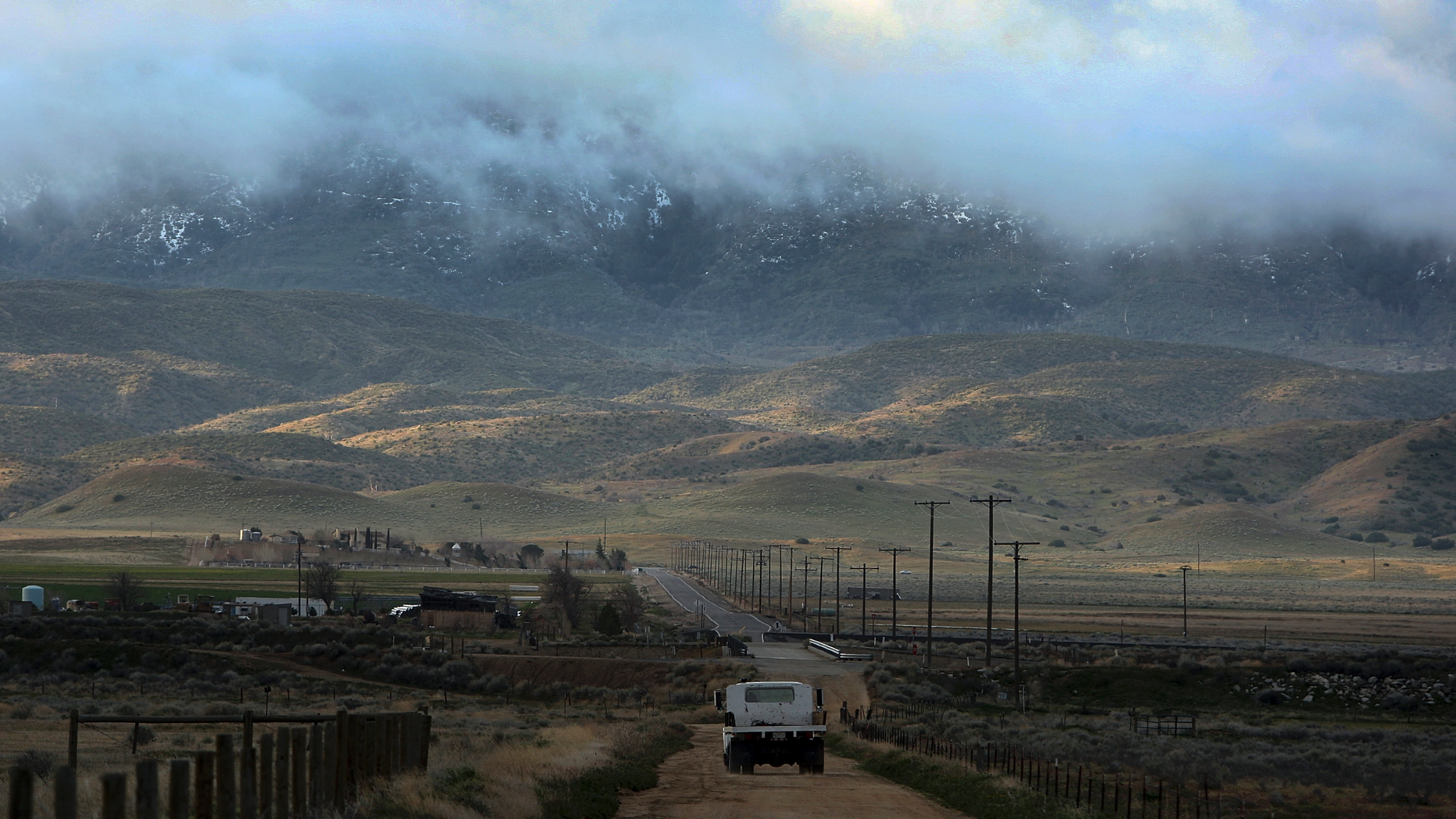 FILE - In March 26, 2011, file photo, threatening clouds are seen at sunrise on Tejon Ranch near Gorman, Calif. A 19,000 home development planned in fire-prone mountains on the outskirts of Los Angeles County faces a final vote from county supervisors on Tuesday, Dec. 11, 2018. The decision comes as critics draw attention to the high fire hazard in the area as the state recovers from deadly and devastating wildfires in Northern and Southern California and tries to solve a major housing crisis. (AP Photo/David McNew, File)