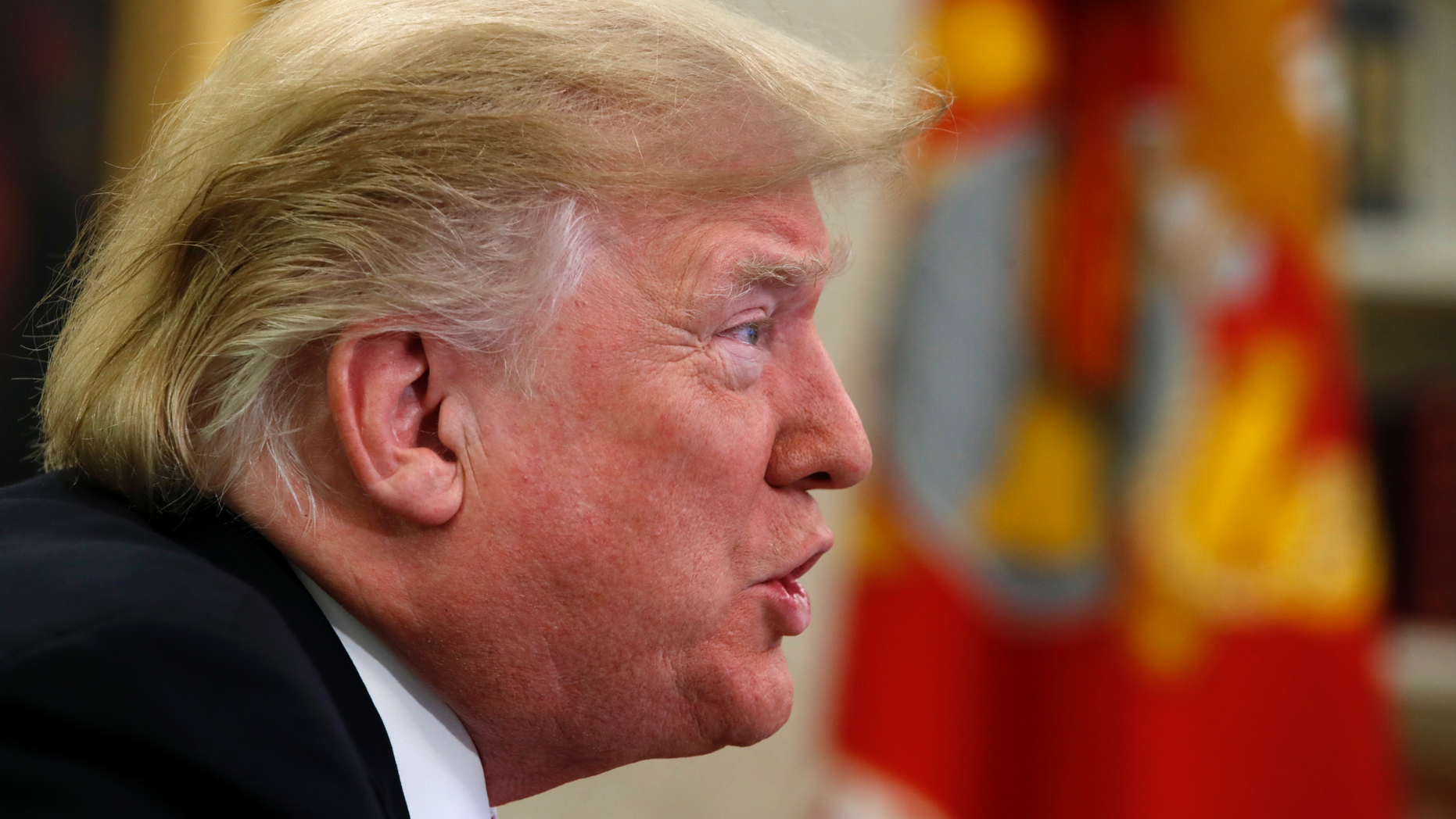 President Donald Trump speaks to members of the five branches of the military by video conference on Christmas Day, Tuesday, Dec. 25, 2018, in the Oval Office of the White House. The military members were stationed in Guam, Qatar, Alaska, and two groups in Bahrain. (AP Photo/Jacquelyn Martin)