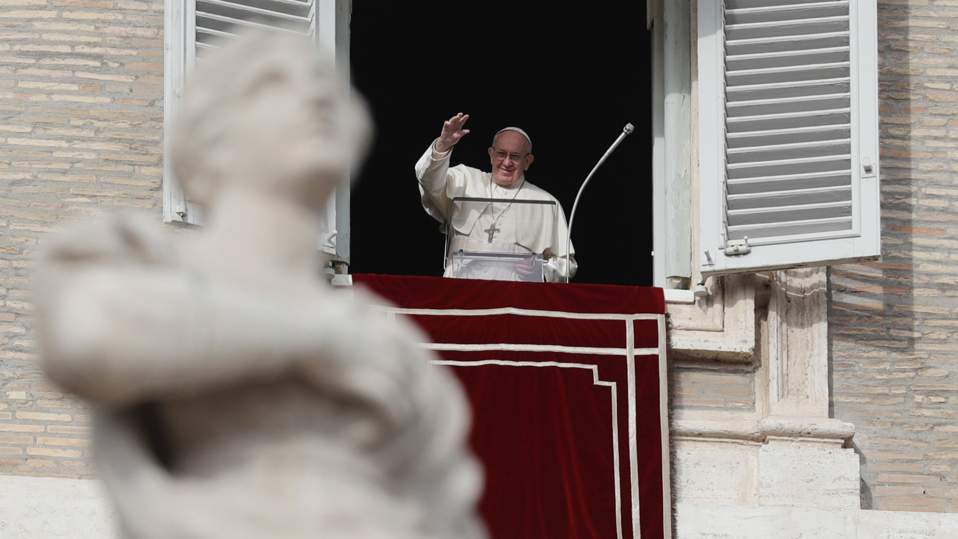 Pope Francis waves to faithful during the Angelus noon prayer in St. Peter's Square, at the Vatican, Sunday, Dec. 16, 2018. (AP Photo/Gregorio Borgia)