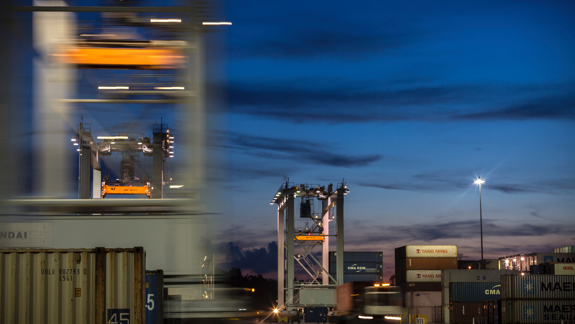 In this July, 5, 2018 photo, a group of rubber tire gantry move to the next stack of shipping containers at the Port of Savannah in Savannah, Ga. On Thursday, Dec. 6, the Commerce Department reports on the U.S. trade gap for October. (AP Photo/Stephen B. Morton, File)