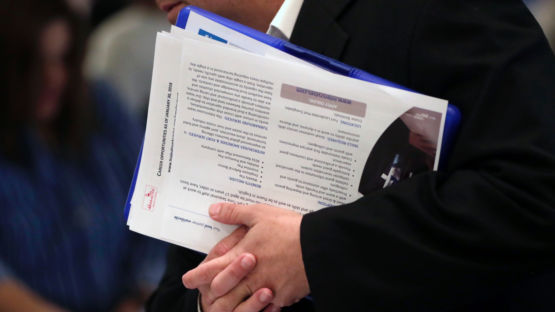 FILE - In this Jan. 30, 2018 file photo, a job applicant talks with company representatives at a JobNewsUSA job fair in Miami Lakes, Fla. Jobs report on Friday, Dec. 7, for November is expected to point to a solid economy for most Americans, with steady hiring, a low unemployment rate and faster wage gains. If so, it would provide a dose of welcome news after this week’s frantic financial market gyrations, which have been driven by concerns that the U.S.-China trade war could escalate and weaken a U.S. economy already facing higher interest rates and slowing global growth. (AP Photo/Lynne Sladky, File)