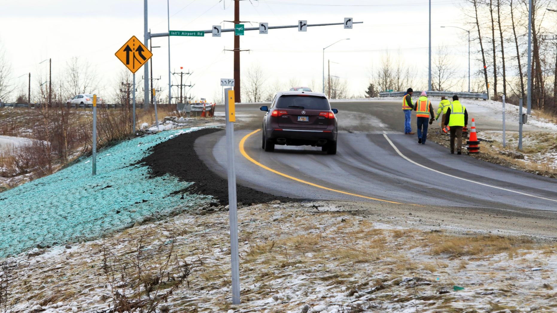 A car ascends a newly repaired off-ramp of Minnesota Drive on Wednesday, Dec. 5, 2018, in Anchorage, Alaska. A massive 7.0 earthquake and its aftershocks rocked buildings and buckled roads Nov. 30, including the road that's a route to Ted Stevens Anchorage International Airport. Alaska transportation officials made rebuilding the ramp a priority. It reopened Tuesday, Dec. 4, and a crew completed shoulder work Wednesday. (AP Photo/Dan Joling)