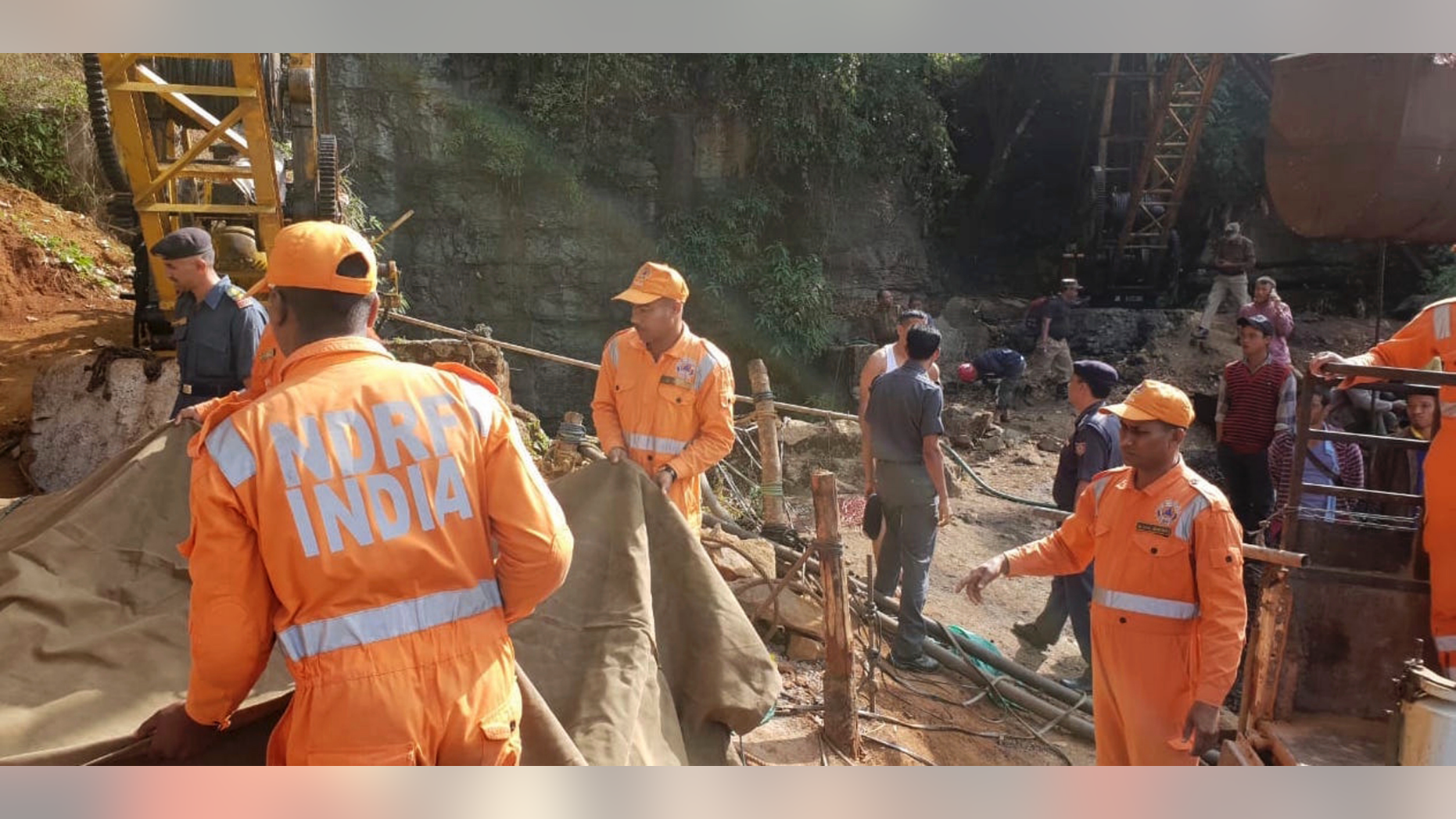 Rescuers work at the site of a coal mine that collapsed in Ksan, in the northeastern Indian state of Meghalaya, Friday, Dec. 14, 2018. Thirteen young miners were missing and feared dead following the collapse of a shaft and flooding of a coal mine they were digging illegally in India's remote northeast, police said Friday. (AP Photo/Sannio Siangshai)