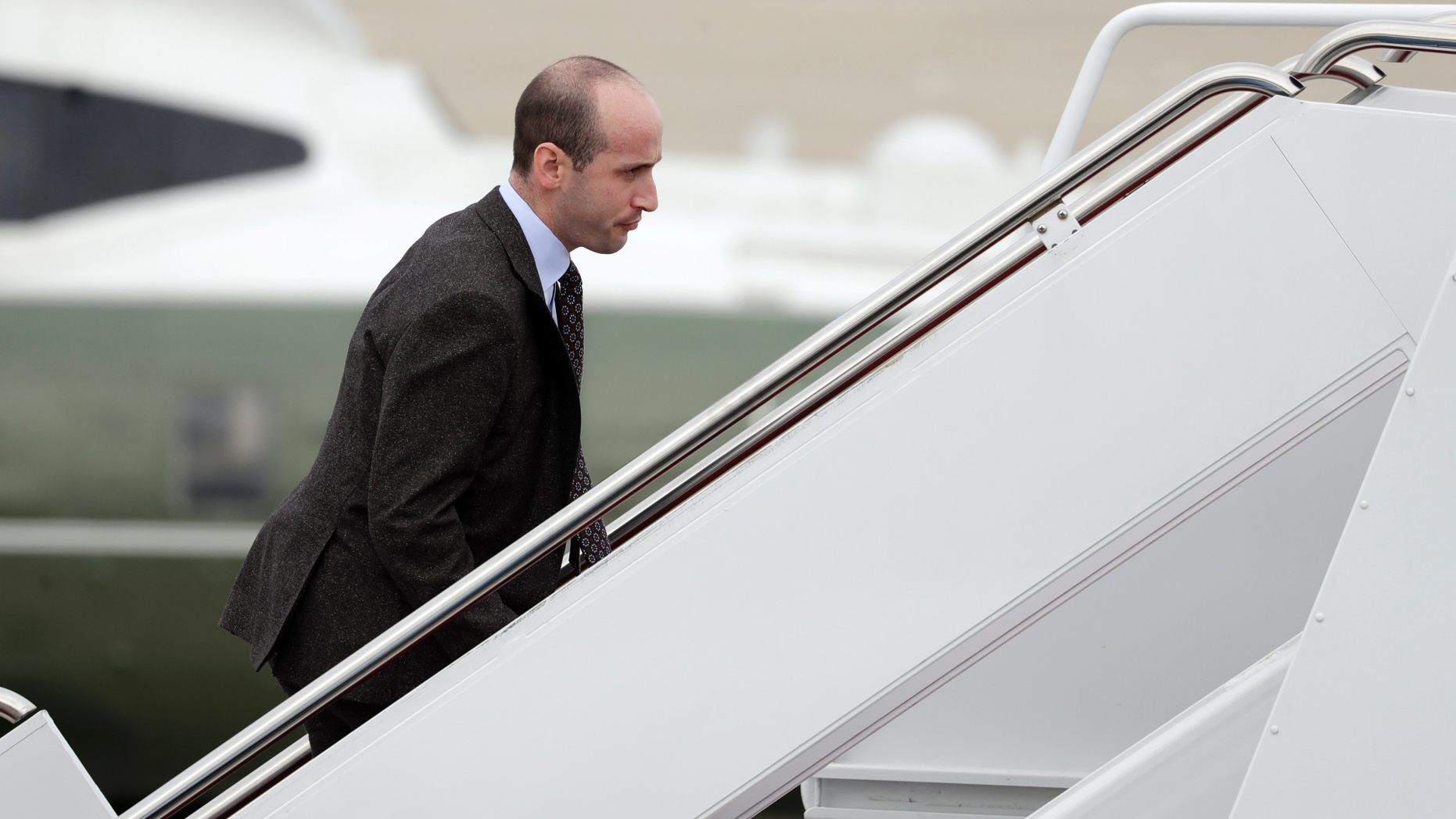 FILE - In this Nov. 2, 2018, file photo, President Donald Trump's White House Senior Adviser Stephen Miller boards Air Force One for campaign rallies in West Virginia and Indiana, in Andrews Air Force Base, Md. The White House is digging in on its demand for $5 billion to build a border wall as congressional Democrats stand firm against it, pushing the federal government closer to the brink of a partial shutdown. Miller says Trump is prepared to do “whatever is necessary” to build a wall along the U.S.-Mexico border. (AP Photo/Evan Vucci, File)
