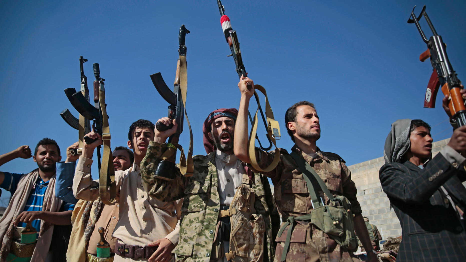 FILE - In this Dec. 13, 2018, file, photo, tribesmen loyal to Houthi rebels hold up their weapons as they attend a gathering to show their support for the ongoing peace talks being held in Sweden, in Sanaa, Yemen. The United Nations has cast doubt on the claims by Yemen’s Shiite rebels to have withdrawn from the port of Hodeida, saying such steps can only be credible if all other parties can verify them.(AP Photo/Hani Mohammed, File)