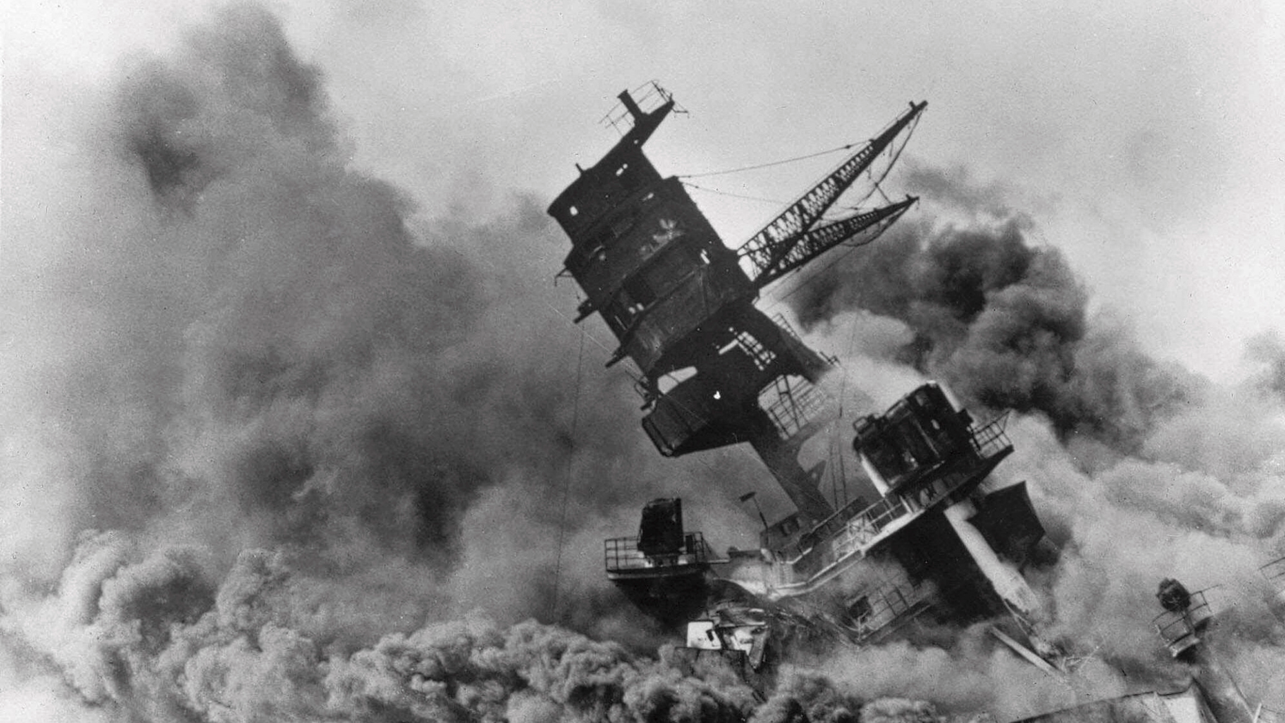 In this Dec. 7, 1941 file photo, smoke rises from the battleship USS Arizona as it sinks during the Japanese attack on Pearl Harbor, Hawaii. About 20 survivors are gathering on Friday, Dec. 7, 2018 at Pearl Harbor to remember thousands of men lost in the Japanese attack 77 years ago. The youngest of the survivors is in his mid-90s. The Navy and National Park Service will jointly host the remembrance ceremony Friday at a grassy site overlooking the water and the USS Arizona Memorial. (AP Photo, File)