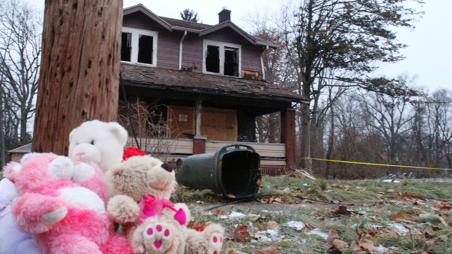 Stuffed animals rest against a pole at a makeshift memorial after a deadly fire in Youngstown, Ohio, Monday, Dec. 10, 2018. Authorities report that several children died in the fire. (William D. Lewis/The Vindicator via AP)