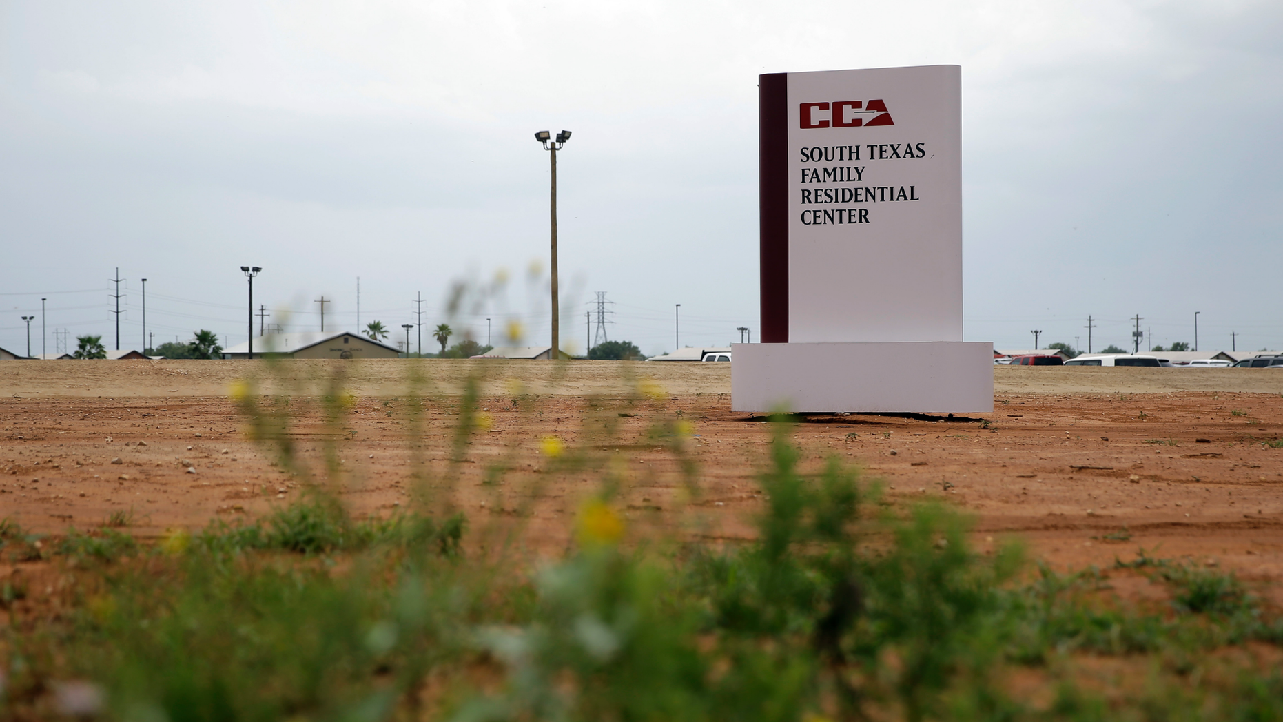 FILE - This June 30, 2015, file photo shows a sign at the entrance to the South Texas Family Residential Center in Dilley, Texas. A judge has ordered Monday, Dec. 24, 2018, the U.S. government not to deport a Honduran woman without her 15-year-old daughter, who have been detained together at the center for six months and fear being attacked if forced to return. (AP Photo/Eric Gay, File)