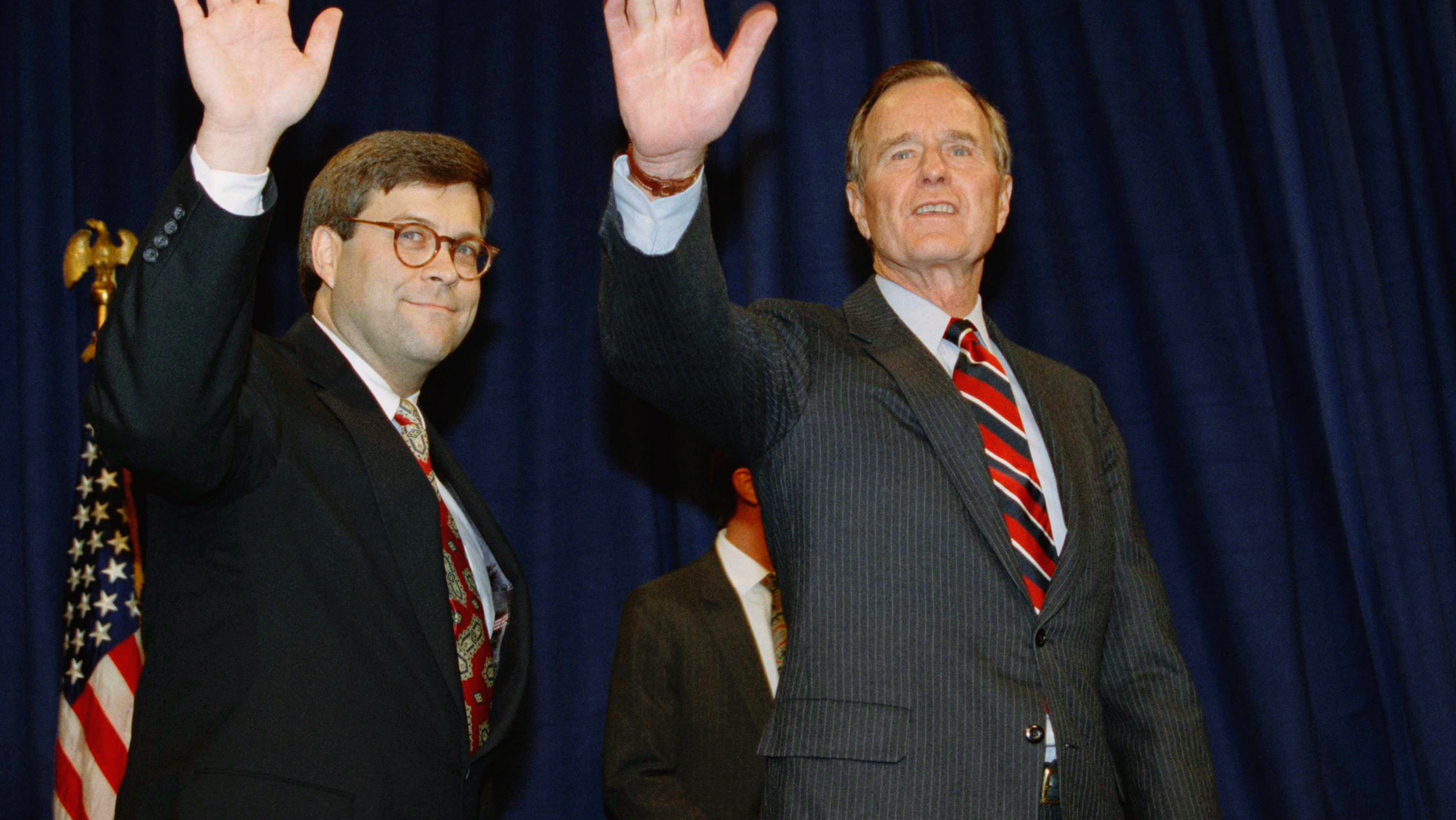 FILE - In this Nov. 26, 1991, file photo, President George H.W Bush, right, and William Barr wave after Barr was sworn in as the new Attorney General of the United States at a Justice Department ceremony in Washington. Barr, President Donald Trump’s pick for attorney general, once questioned the effectiveness of a border wall similar to the one the president now wants to construct. Barr was attorney general under President George H.W. Bush when he was asked in a 1992 interview if he supported a proposal from Republican challenger Pat Buchanan to erect a barrier of ditches and fences along the Mexican border to stem the flow of illegal immigrants. Barr described a side-to-side barrier as “overkill.” (AP Photo/Scott Applewhite, File)