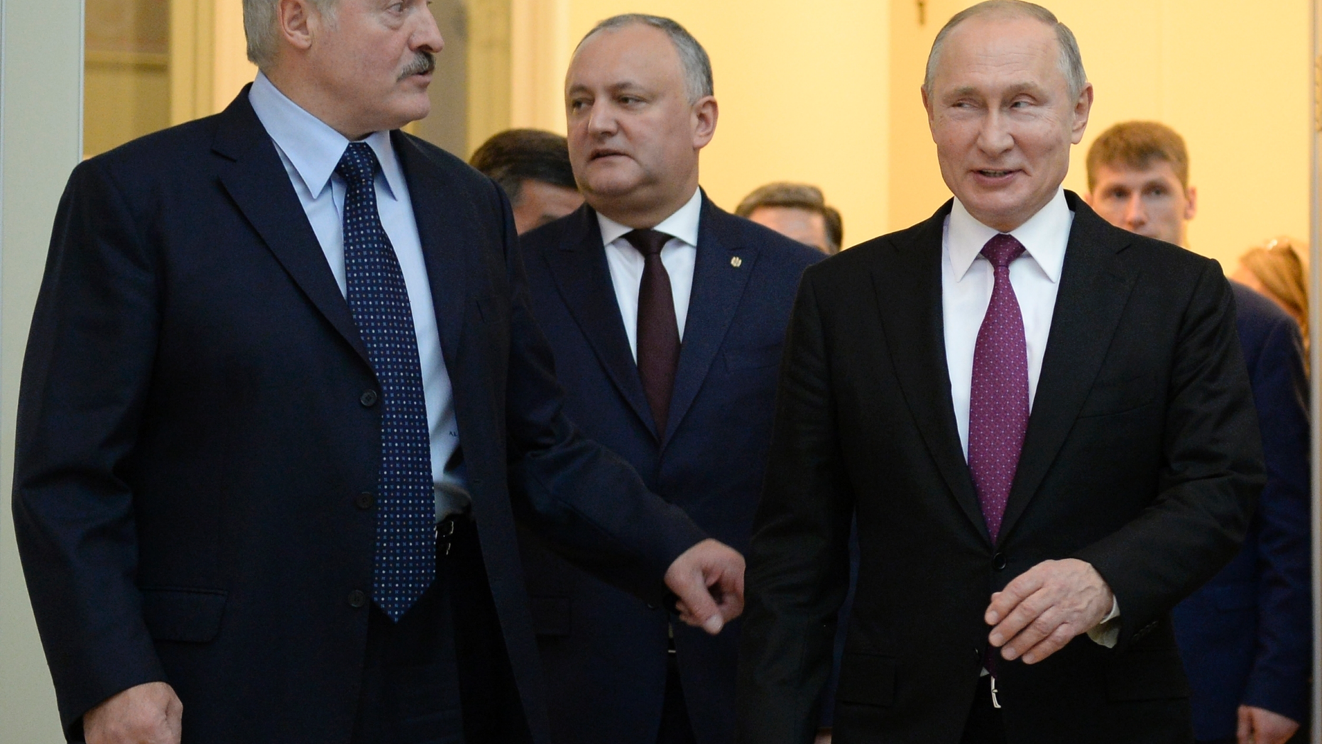 FILE - In this Thursday, Dec. 6, 2018 file photo, Russian President Vladimir Putin, right, Moldova's President Igor Dodon, center, and Belarusian President Alexander Lukashenko talk to each other at the Eurasian Economic Council in St. Petersburg, Russia. Moldova’s electoral campaign began Monday, Dec. 10, 2018 ahead of Parliamentary elections, amid concerns that Russia is seeking to influence the results in the former Soviet republic. The campaign is for the Feb. 24 ballot for the 101-seat legislature (Olga Maltseva, Pool Photo via AP, File)