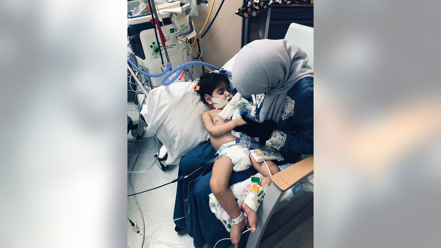 In this Wednesday, Dec. 19, 2018, photo released by the Council on American-Islamic Relations, Sacramento Valley, Shaima Swileh holds her dying 2-year-old son Abdullah at a hospital in Oakland, Calif. Swileh, a Yemeni mother who fought for the right to see her dying son, arrived Wednesday night after the Trump administration gave her a long-sought waiver to its travel ban. (Council on American-Islamic Relations, Sacramento Valley via AP)