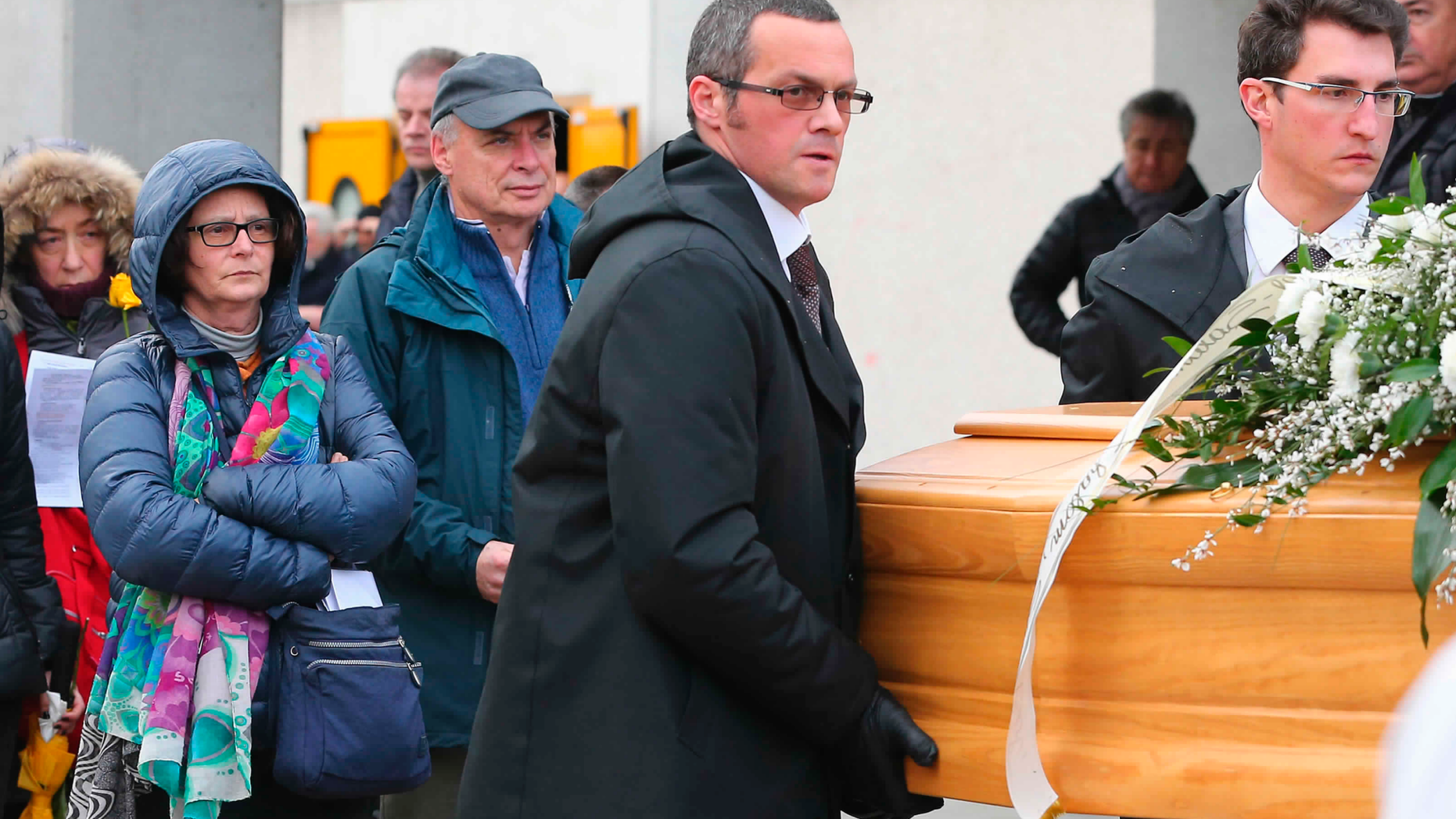 FILE - In this Feb. 12, 2016, file photo, the family of Giulio Regeni follow his coffin during the funeral service in Fiumicello, Northern Italy. Egypt’s official news agency says prosecutors have rejected an Italian request to name several policemen as suspects in the 2016 killing of Regeni, an Italian graduate student in Cairo. The agency’s report, published Monday, Dec. 3, 2018, in state-owned newspapers, says the prosecutors turned down a similar request by the Italians a year ago on the grounds that there was no concrete evidence to incriminate the policemen. (AP Photo/Paolo Giovannini, File)