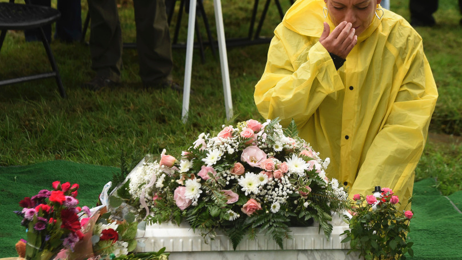 In this Thursday, Dec. 6, 2018, photo, Monica Montejano says The Lords Prayer over the small casket containing the remains of Baby Jane Doe at Sunnyslope Cemetery in Corona, Calif. The newborn infant was found in a cardboard box near the 15 freeway in Corona in July. Corona police and fire departments along with others contributed to make the funeral possible for the child. Police are still searching for the person or persons responsible. (Will Lester, Inland Valley Daily Bulletin/SCNG via AP)