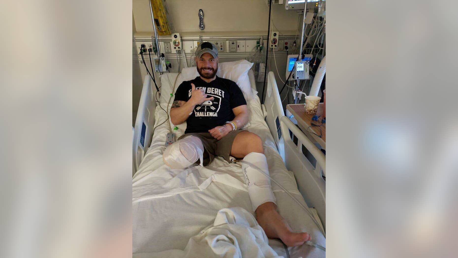 This photo provided by Earl Granville, Alex Douglass gives a thumbs up after his surgery at the Hospital of Special Surgery in Manhattan on Dec. 12, 2018 in New York. The Pennsylvania state police trooper who was shot in a 2014 ambush has had his right leg amputated below the knee. (Earl Granville via AP)