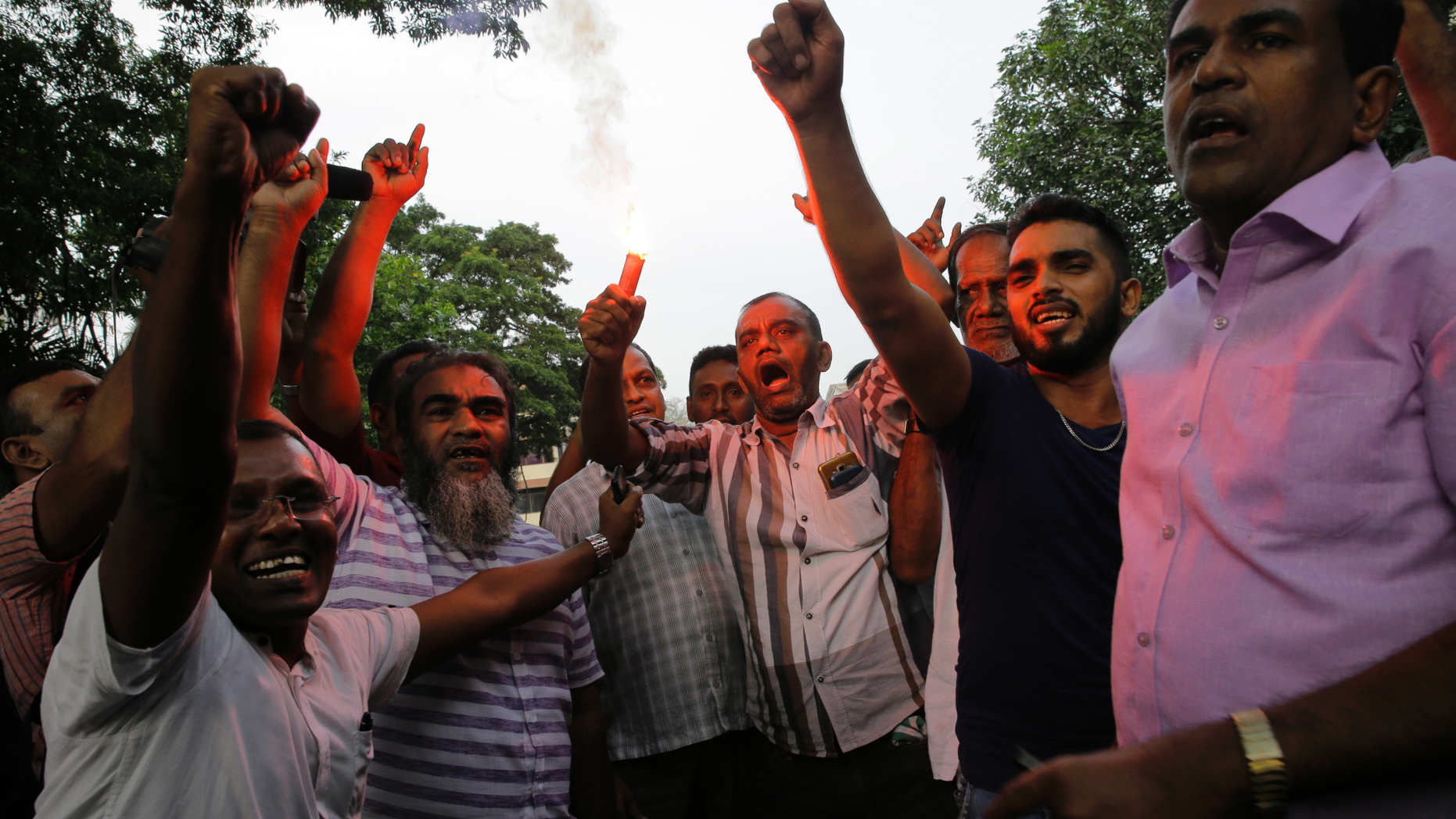 Supporters of ousted Sri Lankan Prime Minister Ranil Wickremesinghe celebrate outside the supreme court complex in Colombo, Sri Lanka, Thursday, Dec. 13, 2018. Sri Lanka's Supreme Court unanimously ruled as unconstitutional President Maithripala Sirisena's order to dissolve Parliament and call for fresh elections, a much-anticipated verdict Thursday that further embroils the Indian Ocean island nation in political crisis.(AP Photo/Eranga Jayawardena)